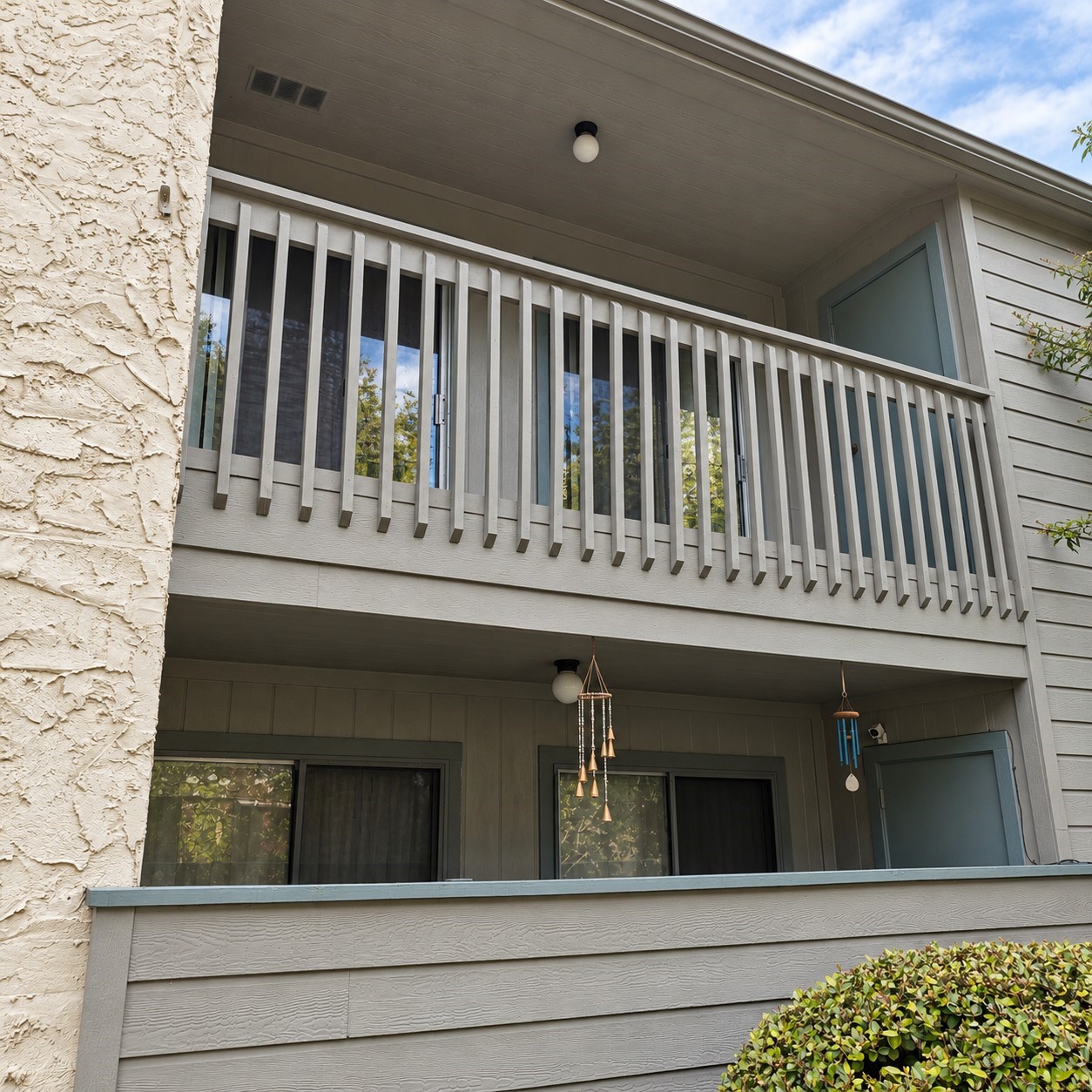 View of the balcony from the walkway to the green area and pool.