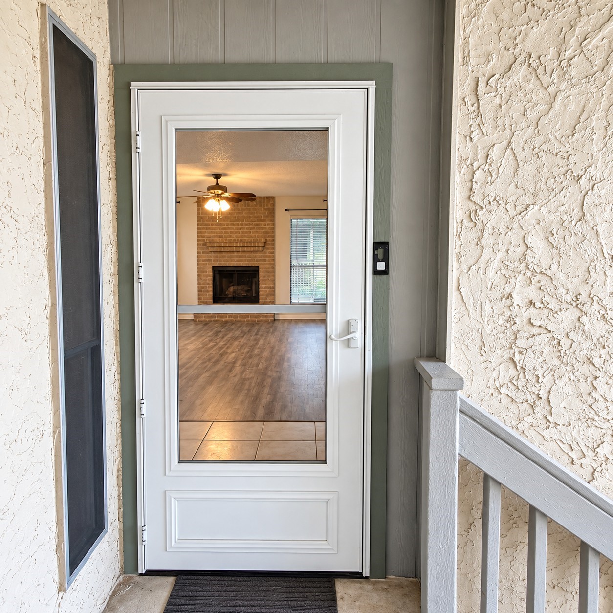 Open door to your dream home -- Front door and Strom screen door welcome you.