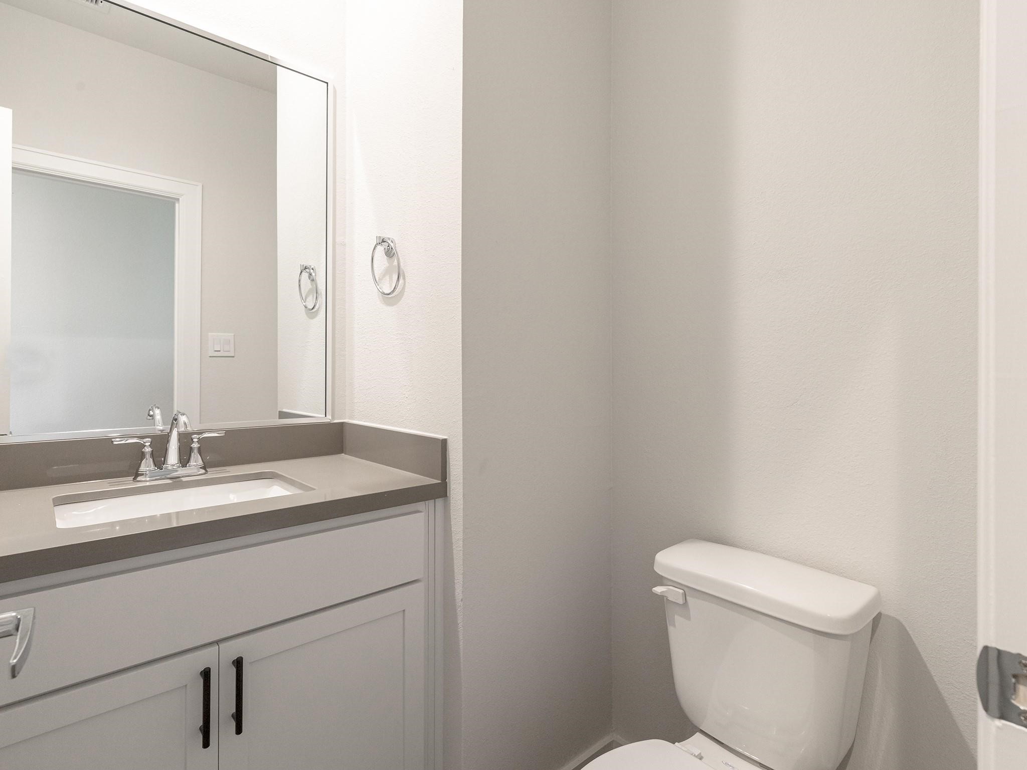Modern half bathroom featuring a sleek vanity with a polished countertop, undermount sink, and contemporary fixtures, complemented by a clean, neutral color palette.
Note: Photos 2022 Modern half bathroom featuring a sleek vanity with a polished countertop, undermount sink, and contemporary fixtures, complemented by a clean, neutral color palette.
Note: Photos 2022