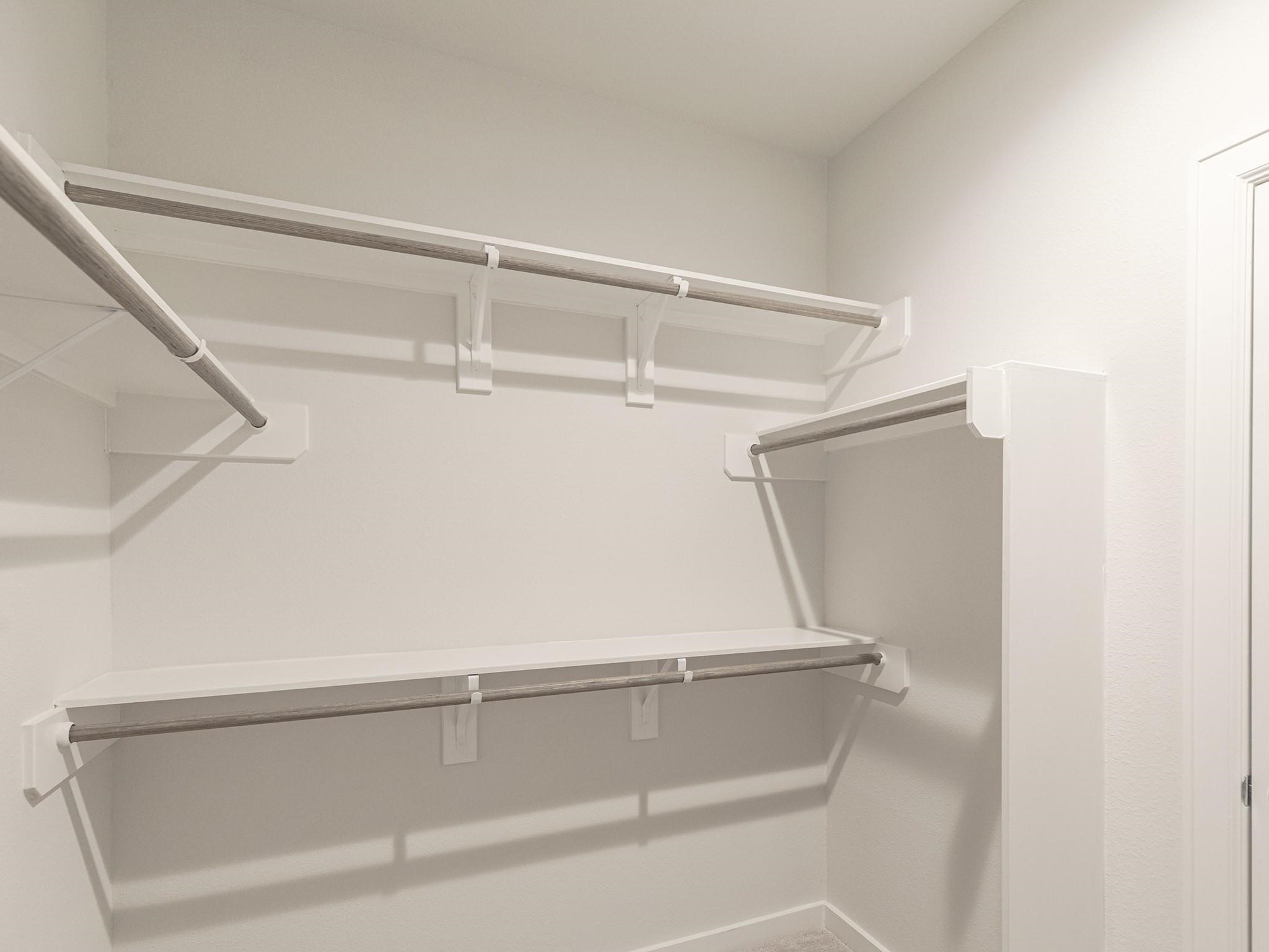 Spacious primary walk-in closet with ample shelving and hanging space for organized storage.

Note: Photos 2022