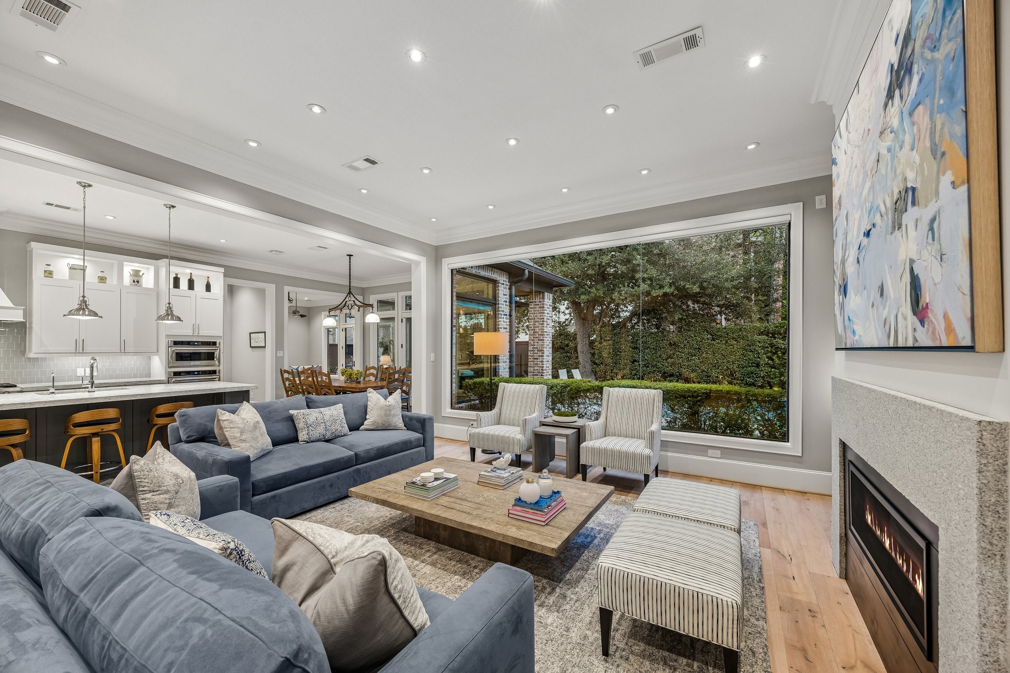 The open-concept design seamlessly connects the Living Room, Kitchen, Breakfast and Den areas.