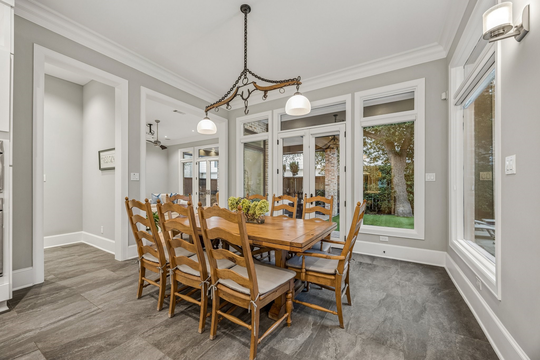 Eat-In Breakfast area with French Doors that lead to the covered patio.  Rustic-inspired linear chandelier and tons of natural light flood the space.