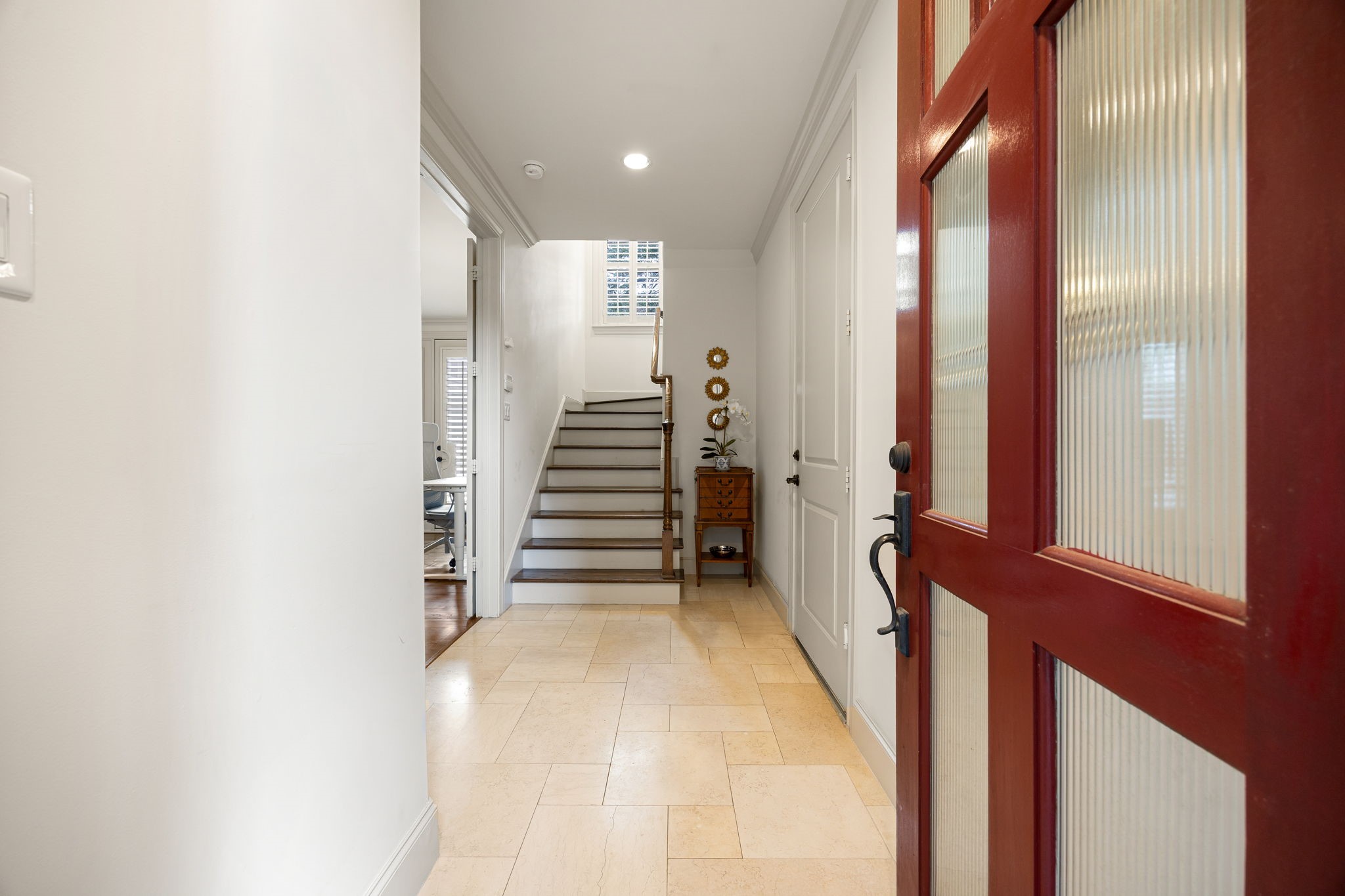 Upon entering the home, you will notice one of the secondary bedrooms and the garage entry.  The space is light and open and the staircase leads you to the main living floor.
