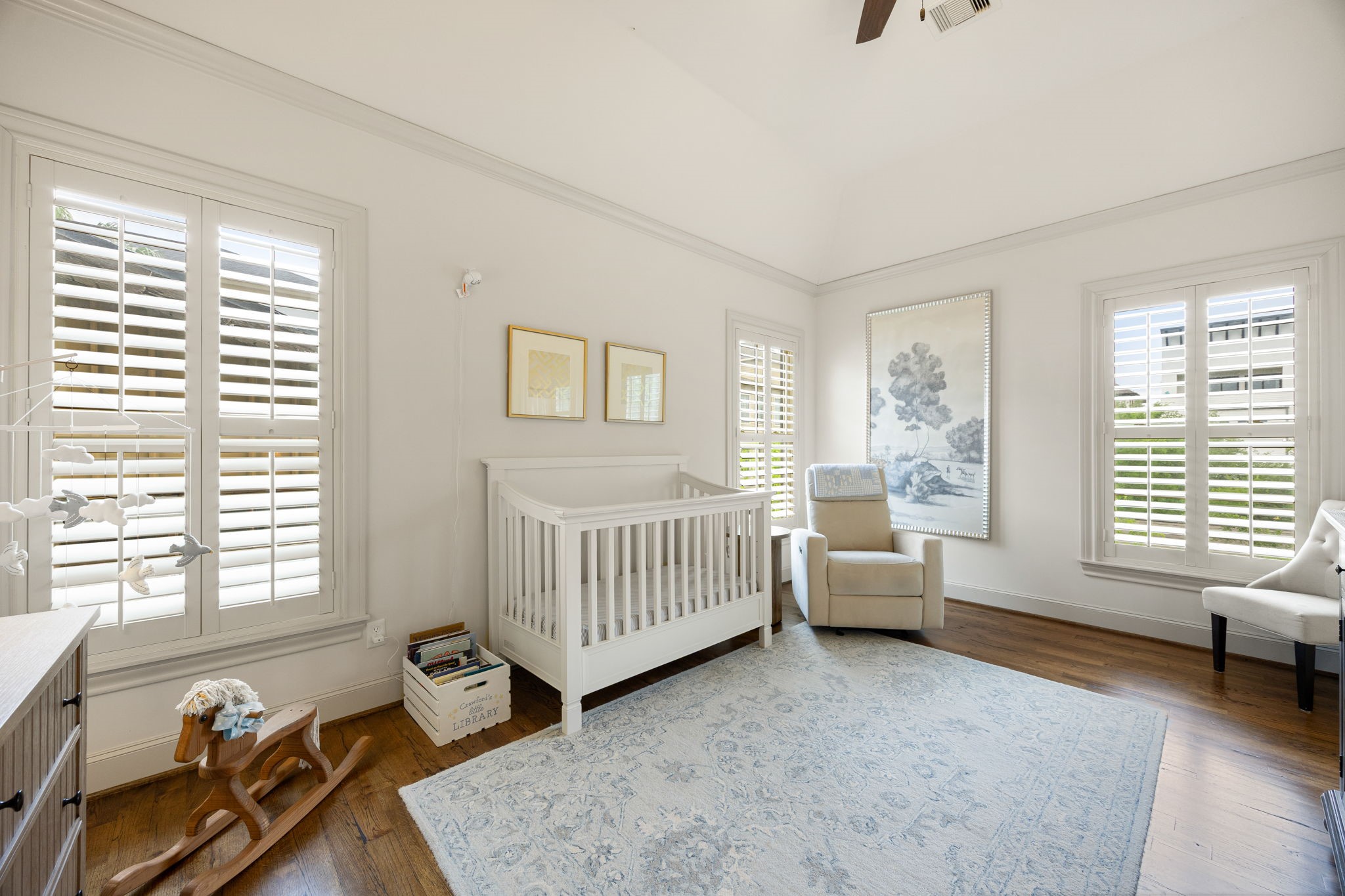 This secondary bedroom is being used as a nursery. The hardwood floors and large windows make it a beautiful space for a bedroom, office or flex room. It has it's own private full bathroom as well.
