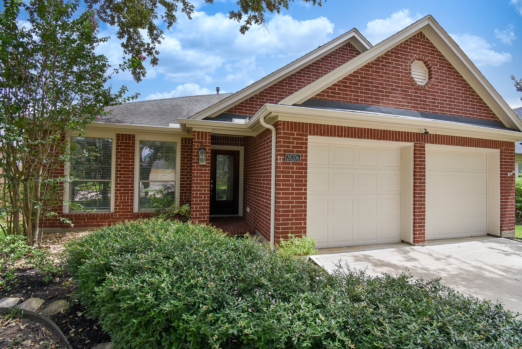Inviting covered front entry framed by timeless brick architecture and mature landscaping. This beautifully maintained home offers warmth, charm, and exceptional curb appeal from the moment you arrive.