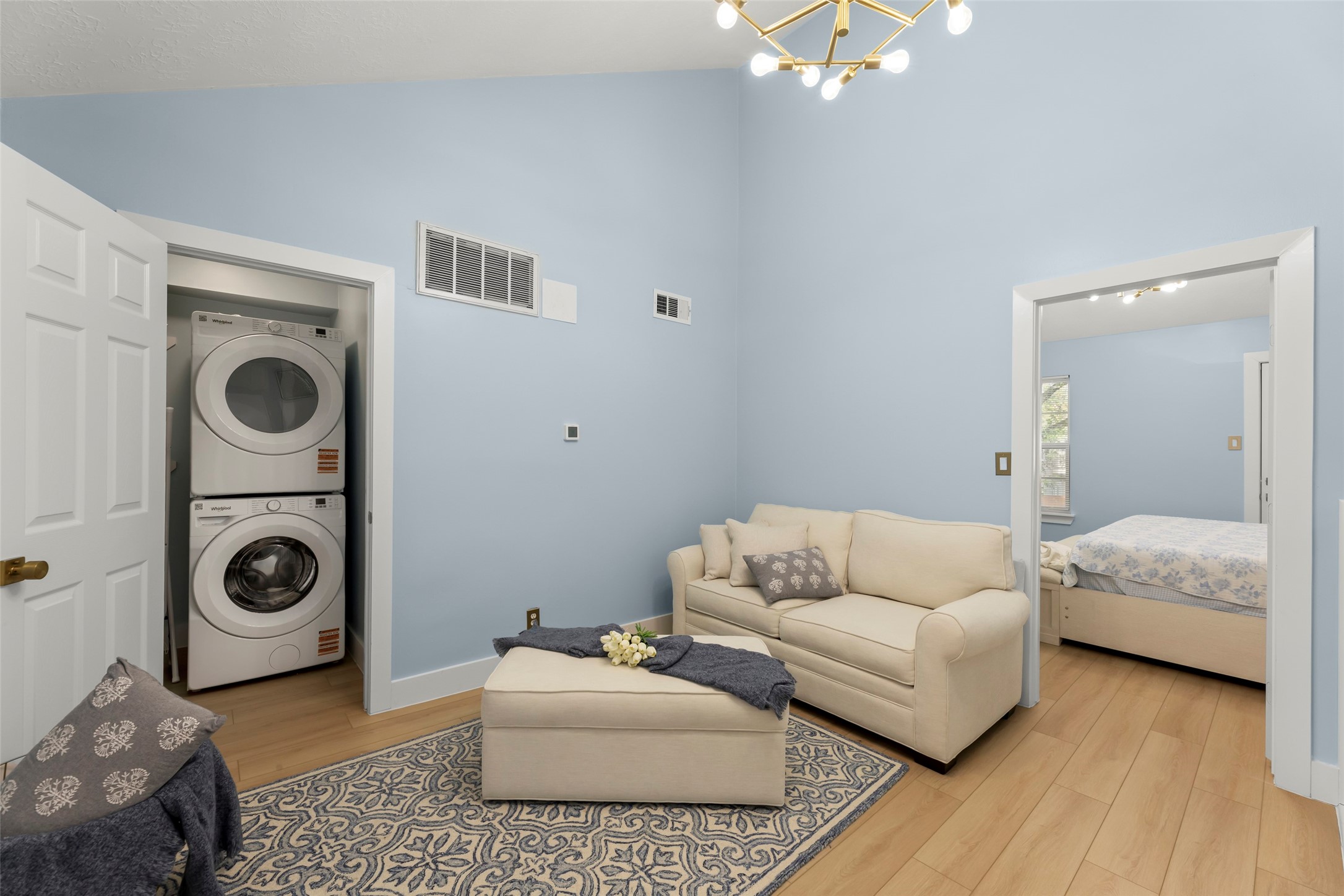 Experience versatility with a stylish flex area perfect for a home office or hosting guests, complete with a convenient laundry setup and a comfortable sofa-bed.
