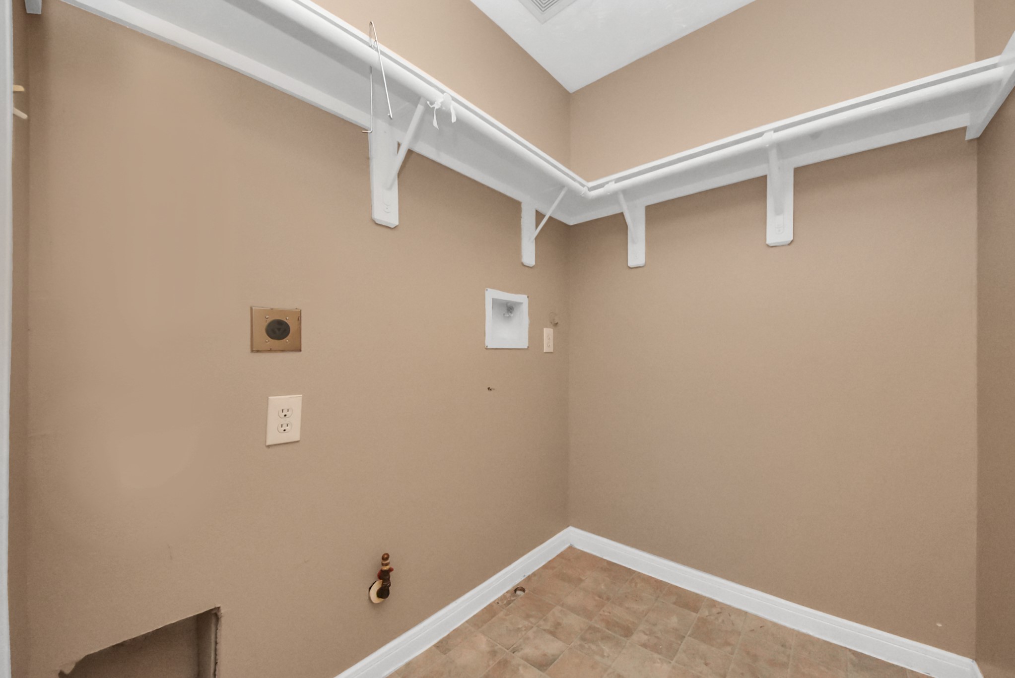 Nice-sized utility room with convenient storage shelves to help keep everything organized.