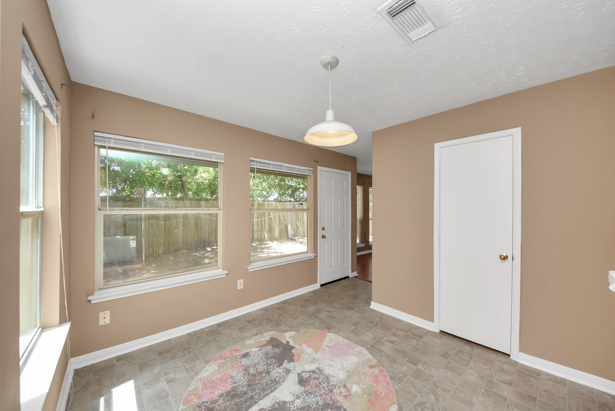 Another view of the breakfast area looking out to the patio. Natural light comes in throughout the day, creating a bright and pleasant space for cooking and enjoying your meals.
