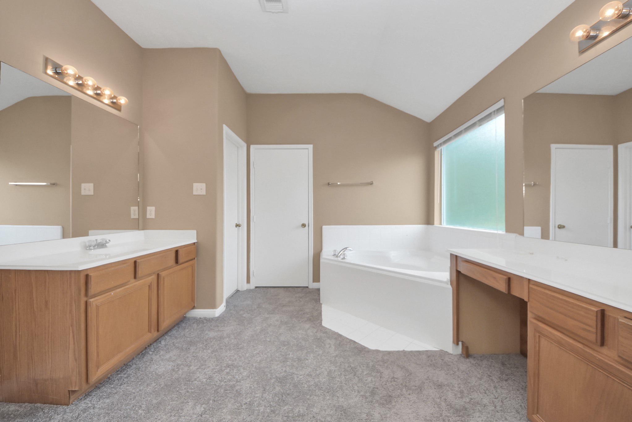 The primary bathroom offers dual sinks, a relaxing garden tub, a separate walk-in shower, and a convenient makeup vanity.
