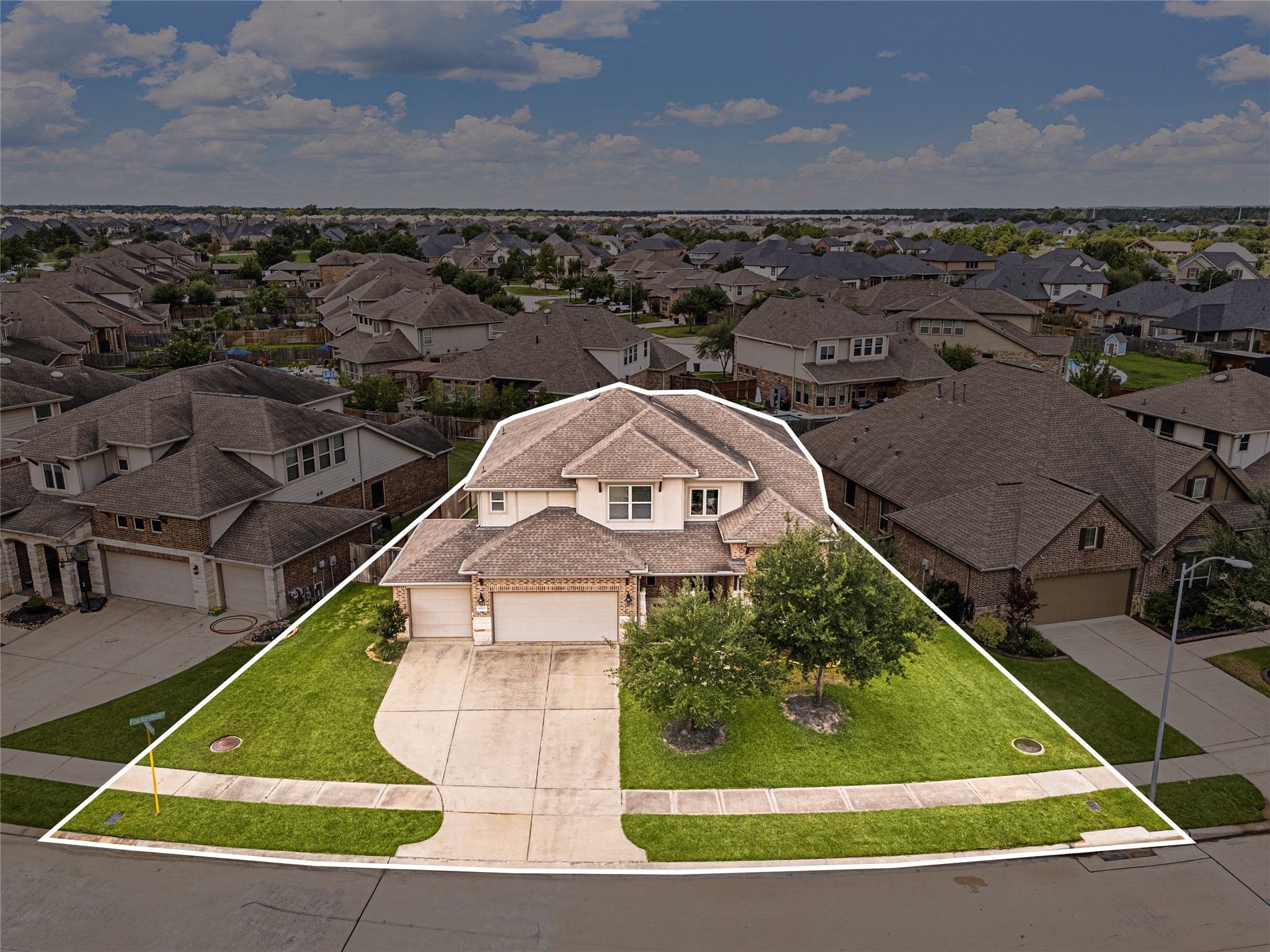 Spacious two-story home with a well-maintained lawn, three-car garage, and charming curb appeal, nestled in a friendly neighborhood.