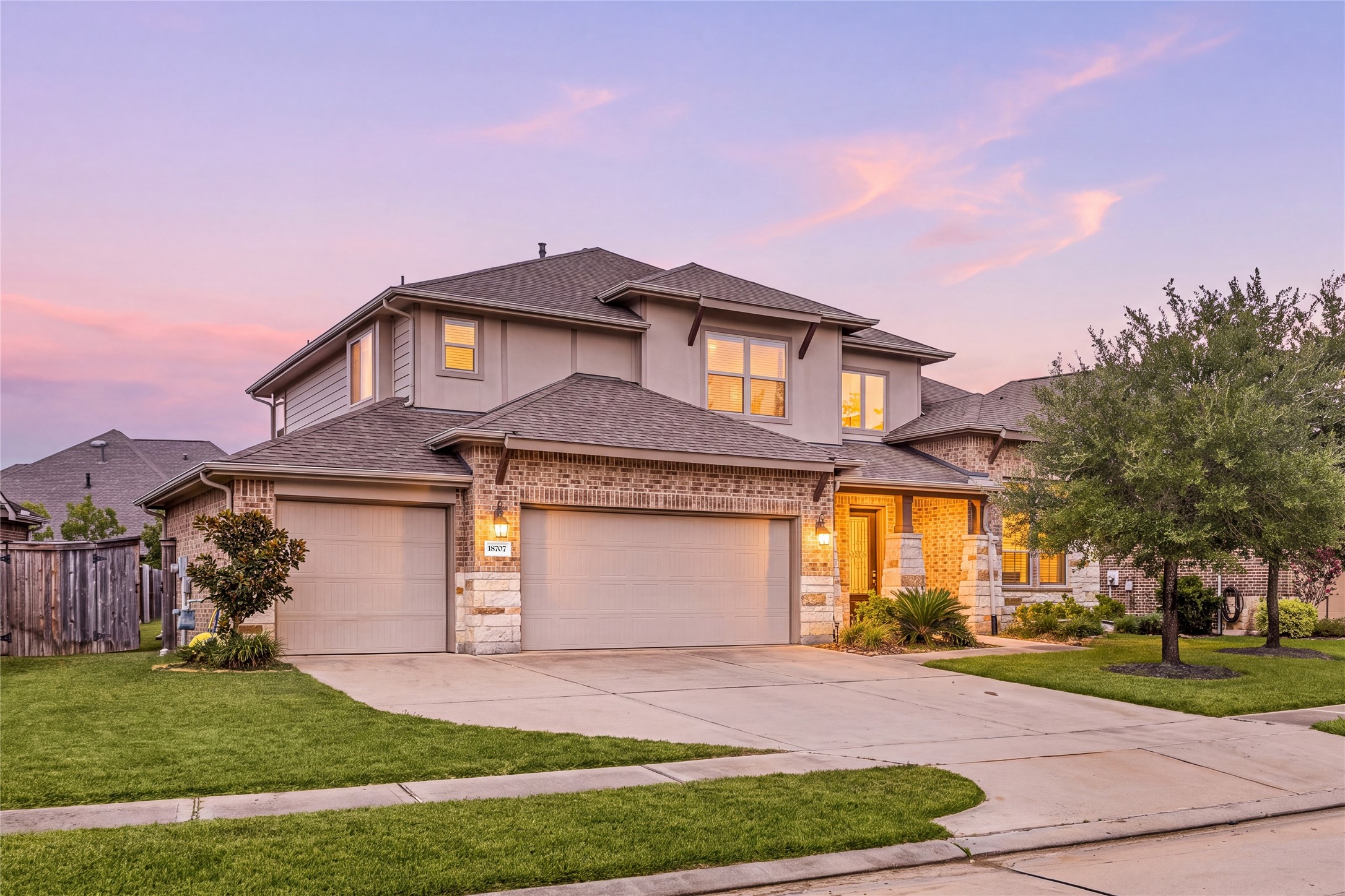 Stunning two-story home with a brick and stone facade, featuring a spacious three-car garage and beautifully landscaped front yard. Stunning two-story home with a brick and stone facade, featuring a spacious three-car garage and beautifully landscaped front yard.