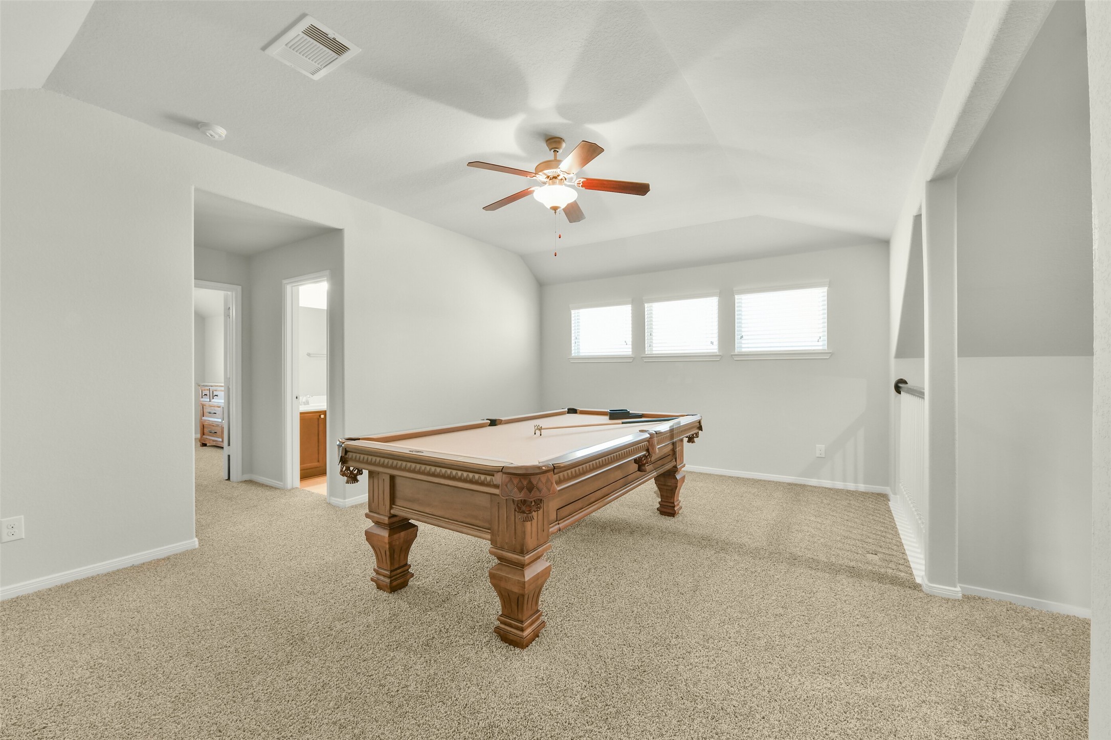 A large game room 18+'x13' upstairs with lots of natural light