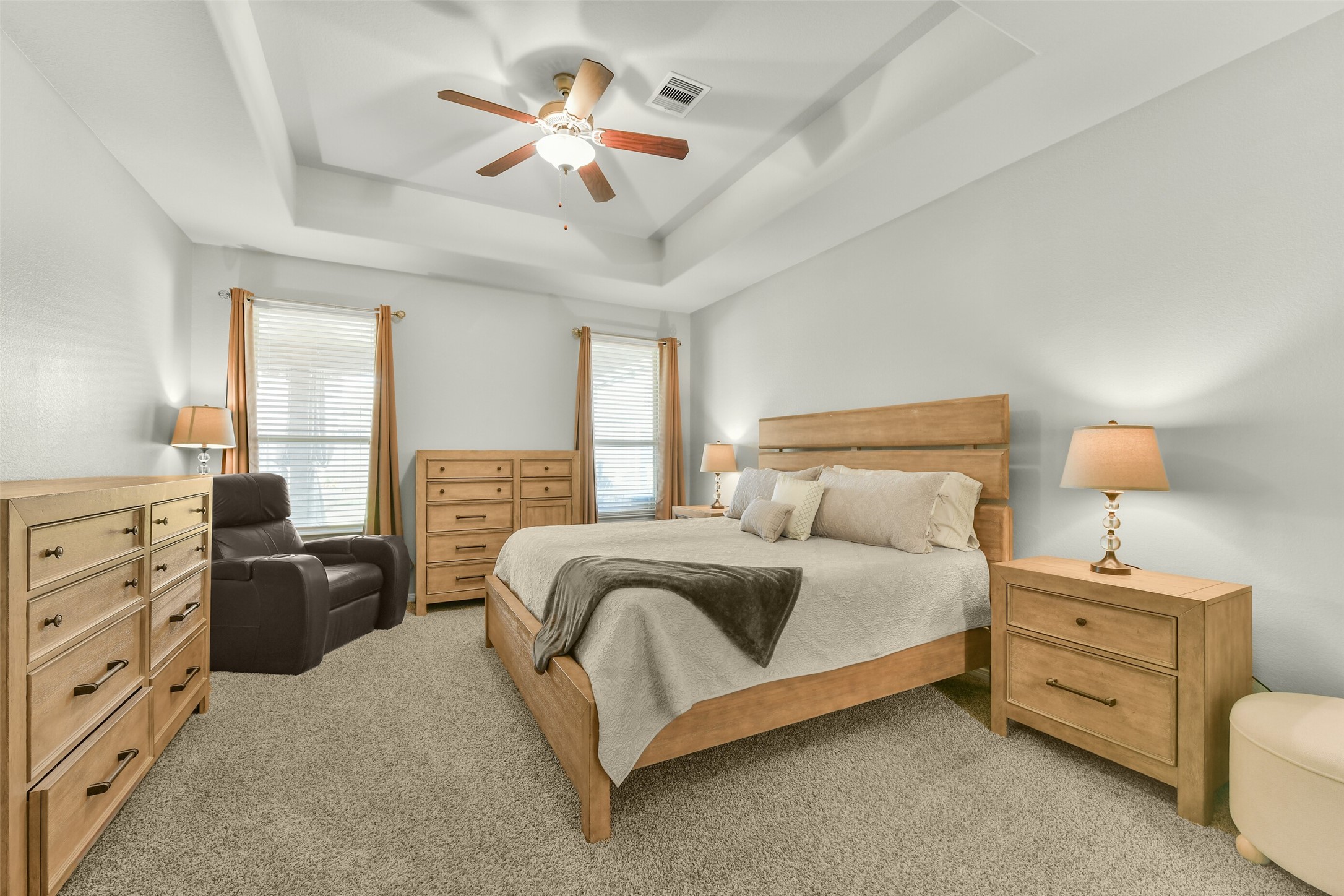 Large master bedroom with neutral fresh paint coffered ceilings and views overlooking large covered patio