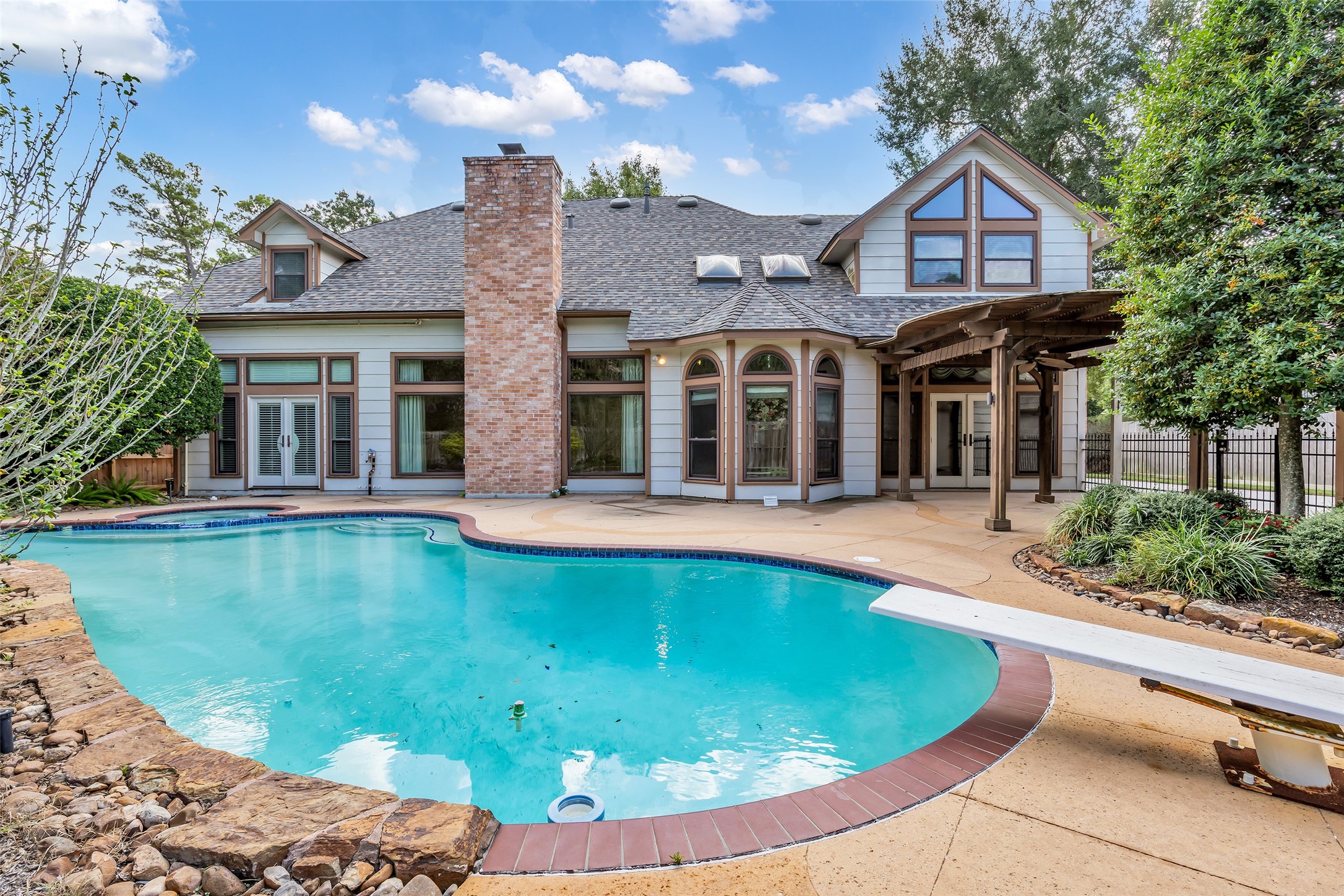 Private pool surrounded by mature landscaping and an expansive patio.