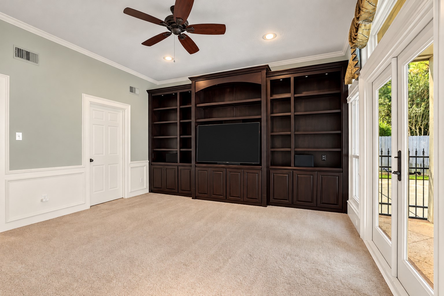 Separate den with entertainment center and access to the pool area.