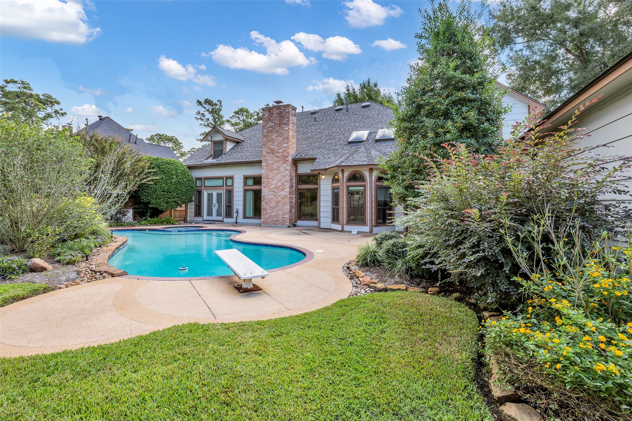Private pool surrounded by mature landscaping and an expansive patio.