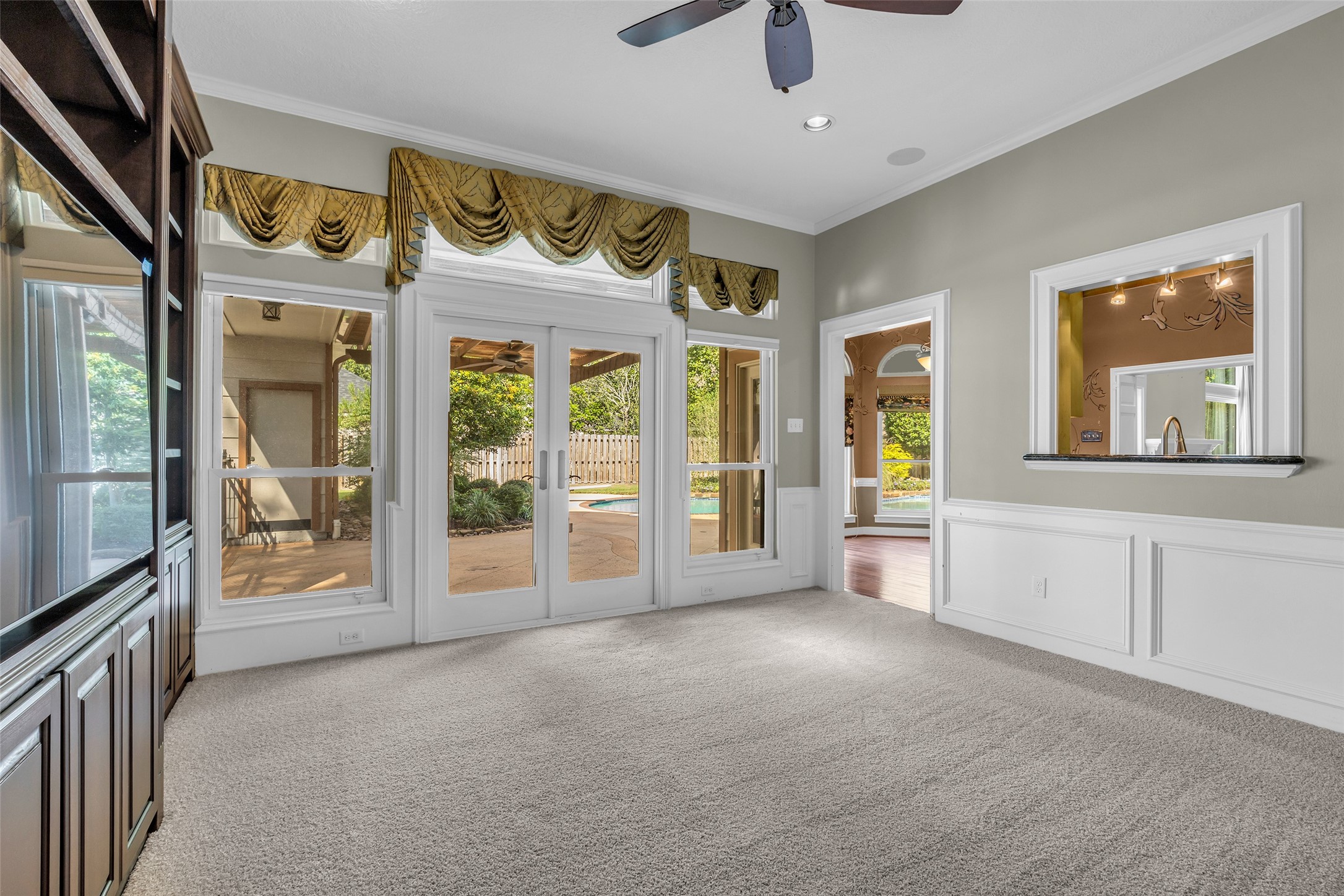 Separate den with entertainment center and access to the pool area.