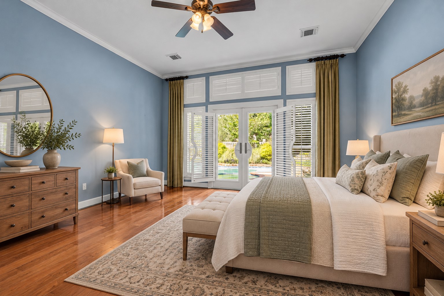 *VIRTUALLY STAGED* Spacious first-floor primary bedroom with hardwood floors, high ceilings, and French doors overlooking the private pool.