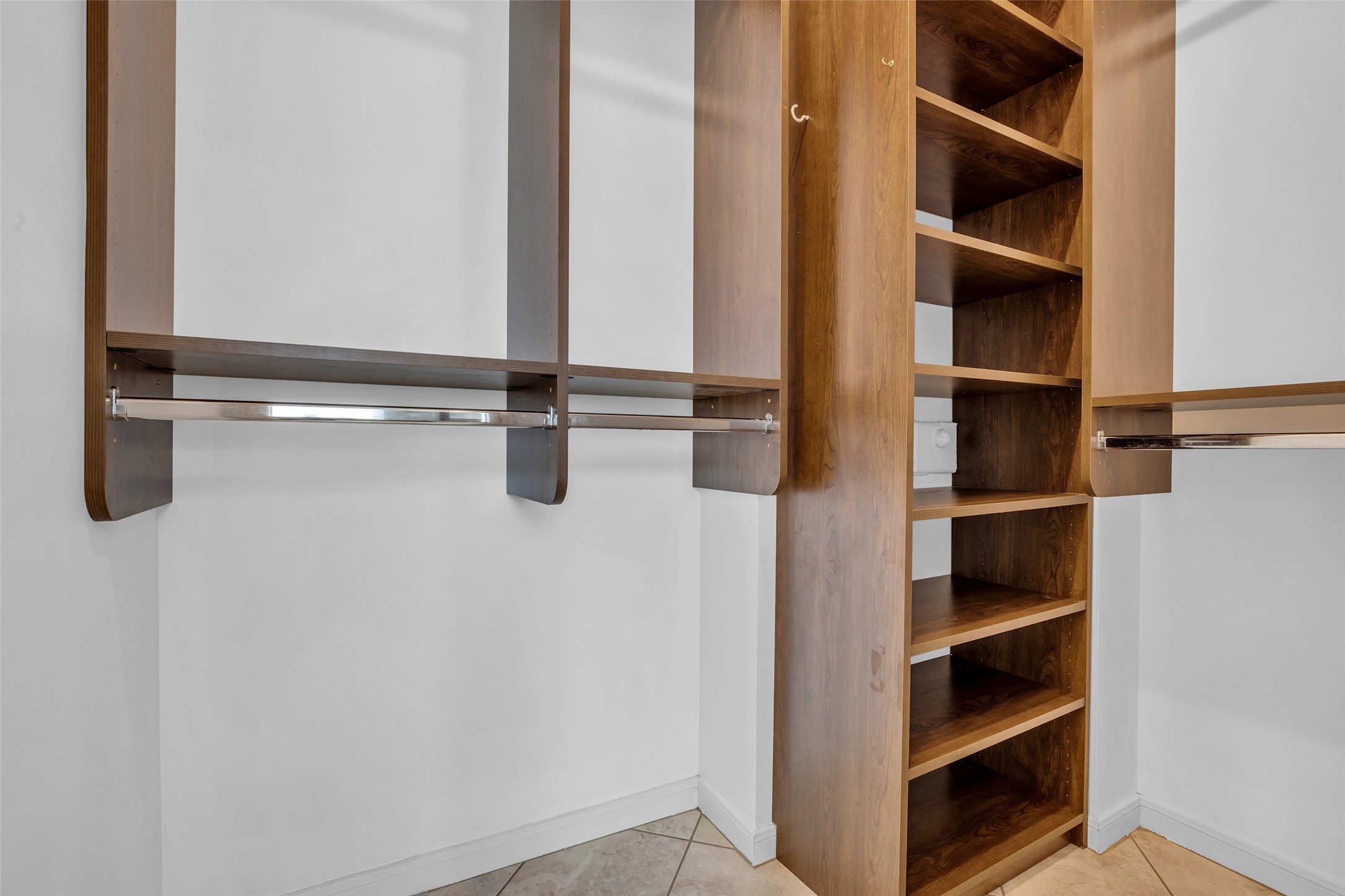 One walk-in-closet with closet system.
