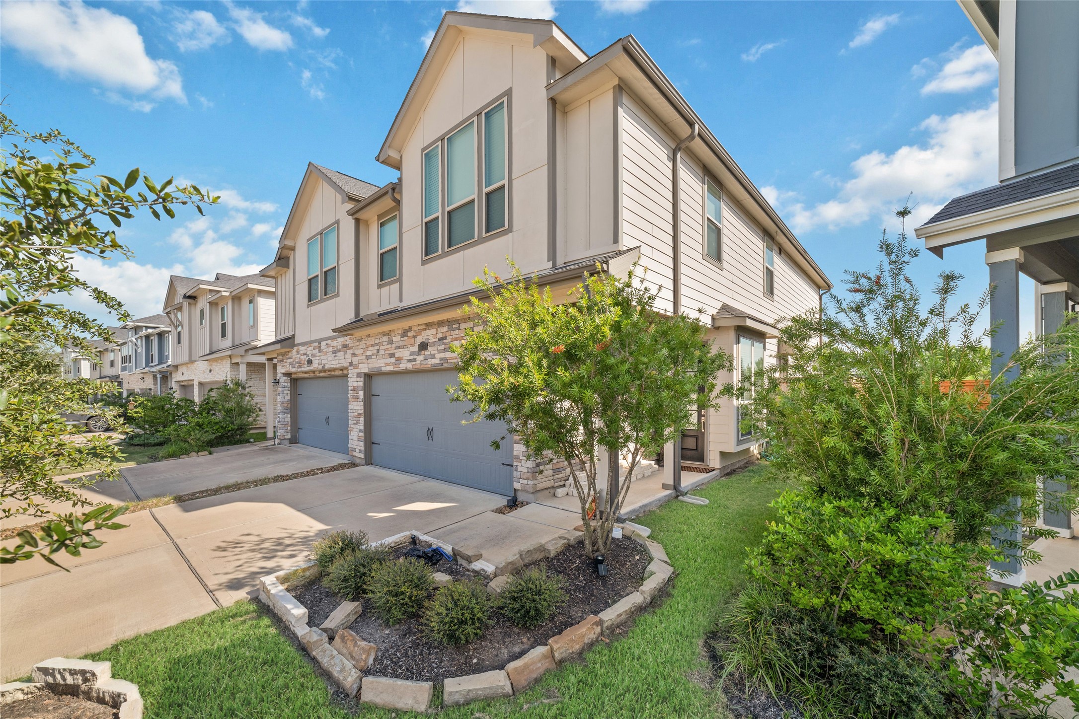 Built in 2022, this attractive corner-unit townhome features traditional architecture, stone accents, manicured landscaping, and a welcoming exterior.