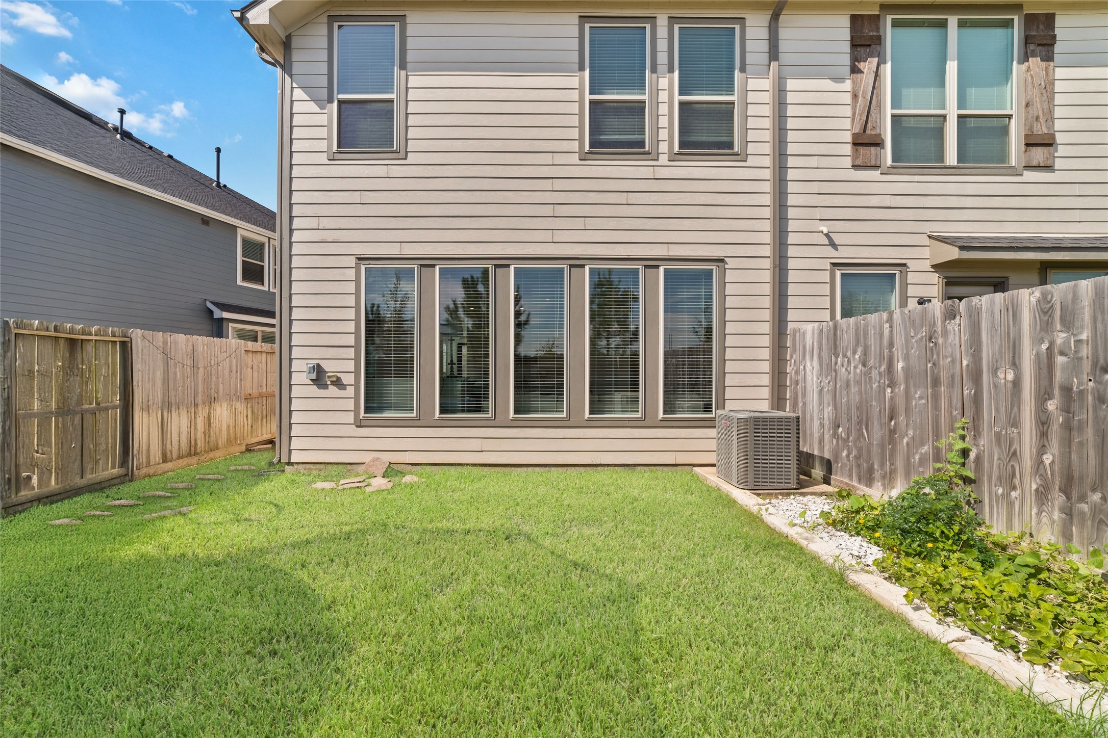 Enjoy a private fenced backyard with green space for outdoor relaxation, entertaining, or enjoying the Texas sunshine.
