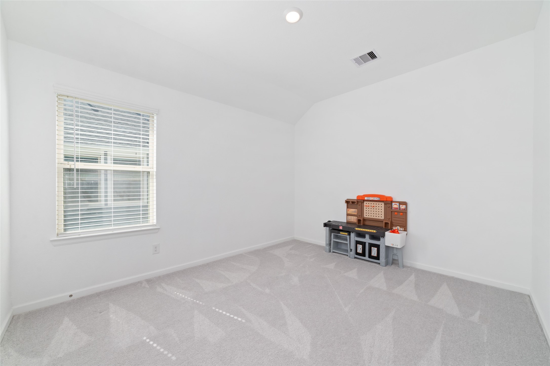 The upstairs game room offers versatile additional living space, ideal for a media area, home office, playroom, or casual gathering space.