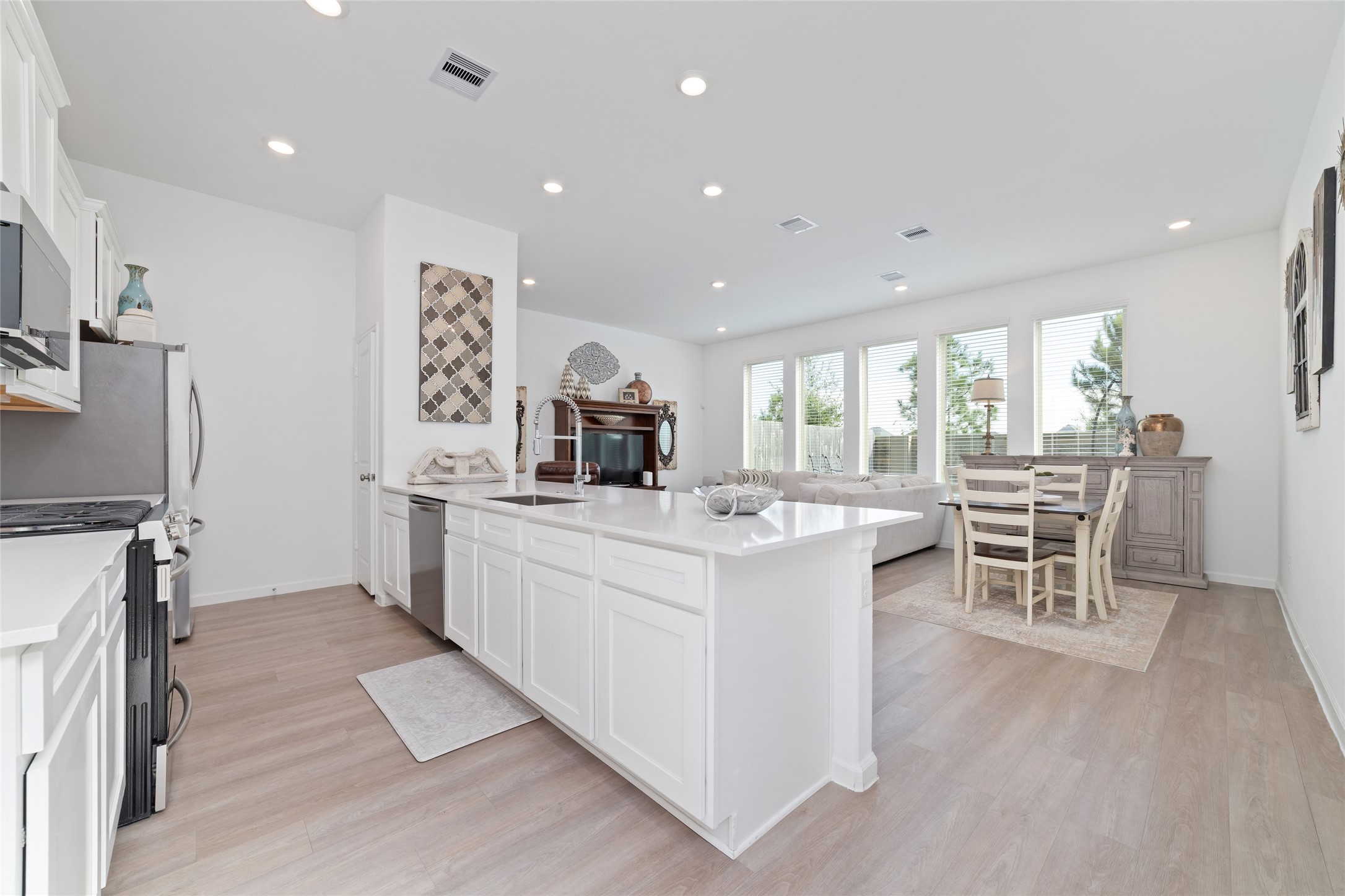A spacious center island provides additional preparation space and casual seating while connecting the kitchen to the open-concept family room.