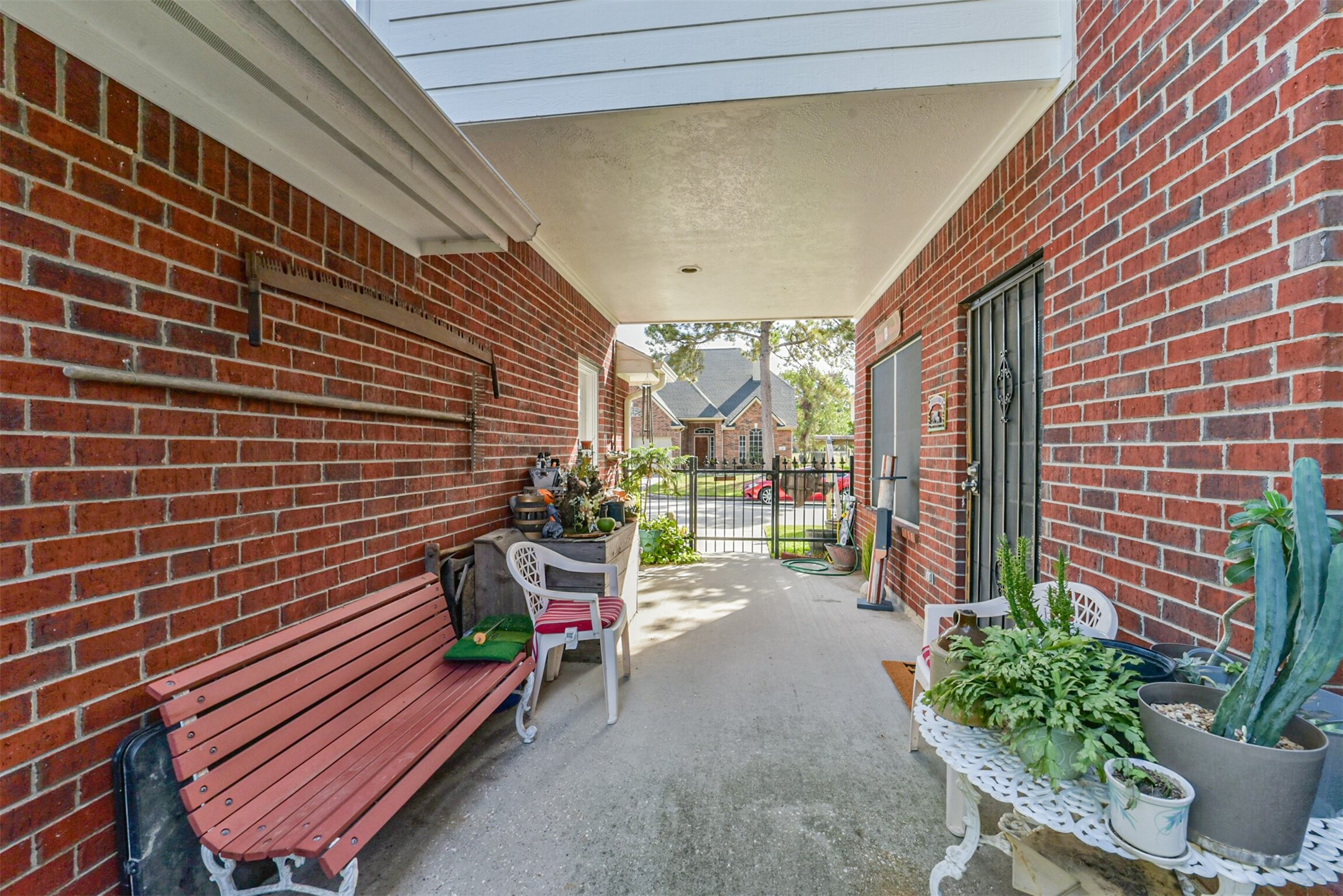 Relax in the cool shade of the covered breezeway, a perfect spot for unwinding or entertaining guests.