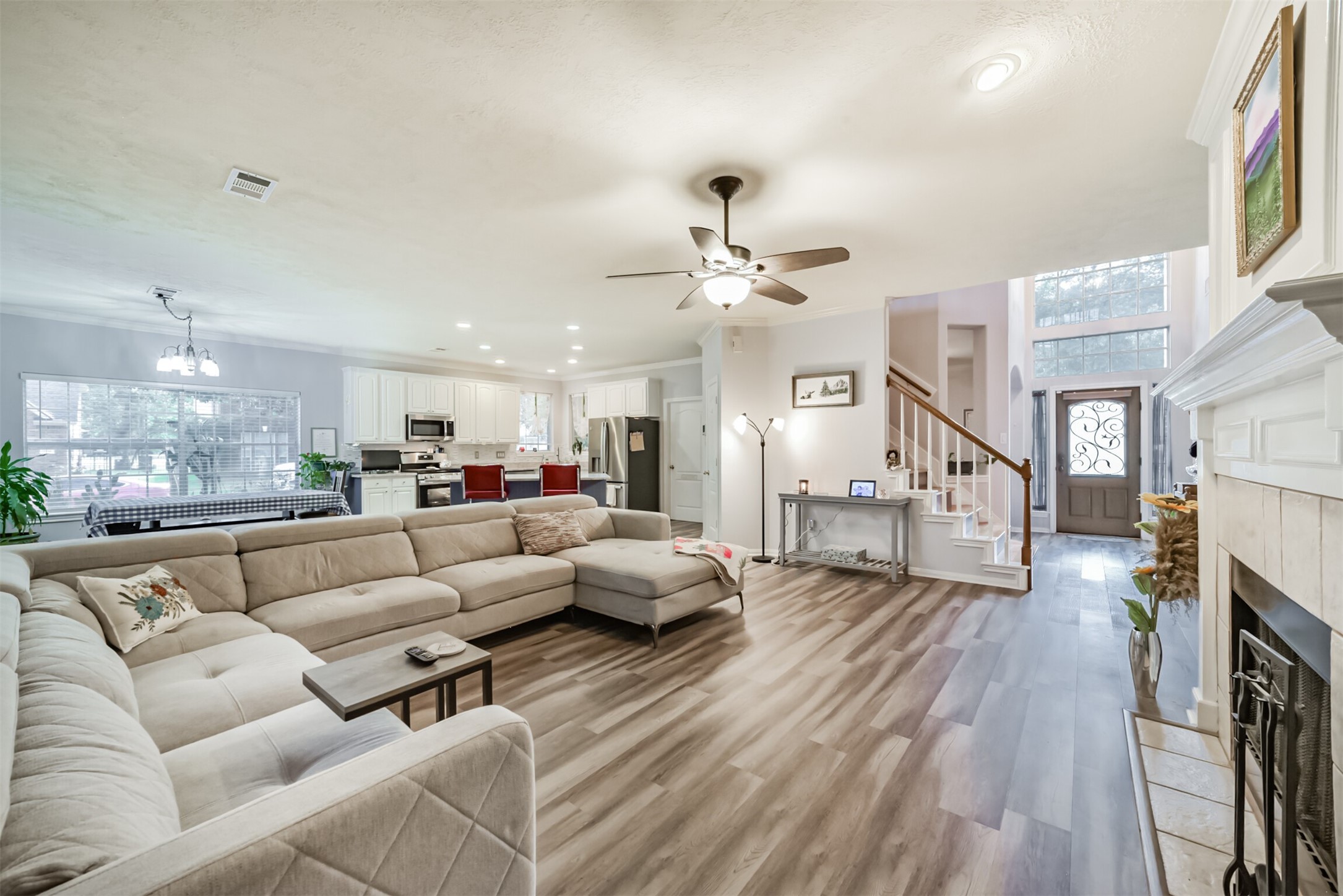 A view of the open-concept home from the family room, softly lit by ambient lighting.