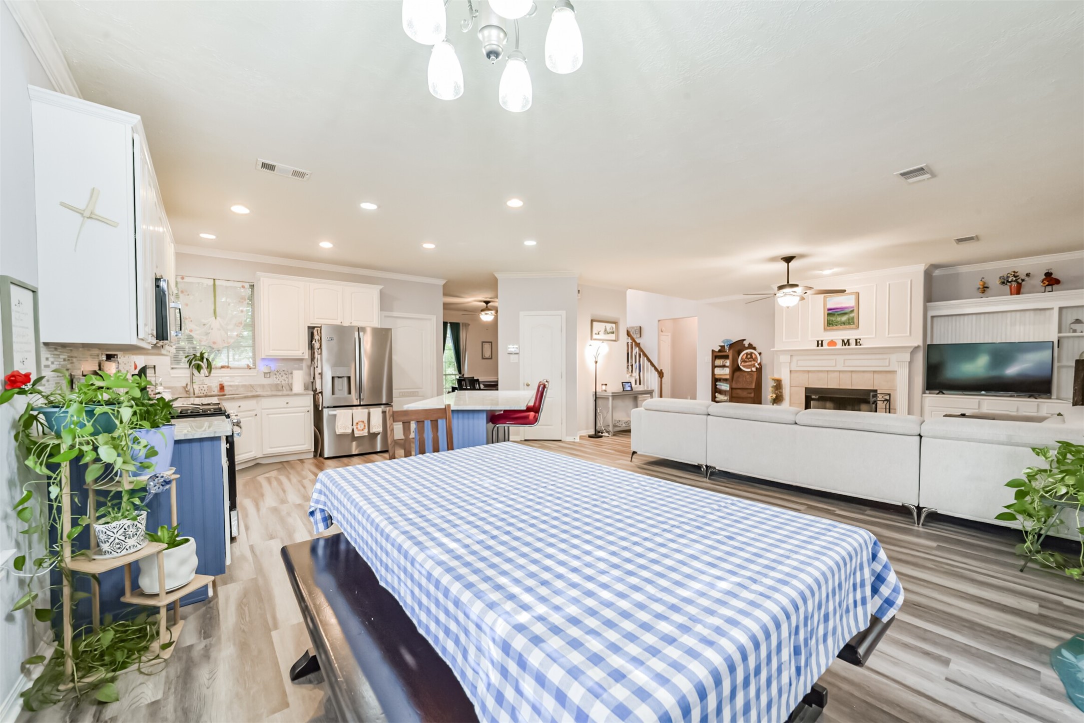 A view of the home's breakfast room, with a designer light fixture hanging overhead.