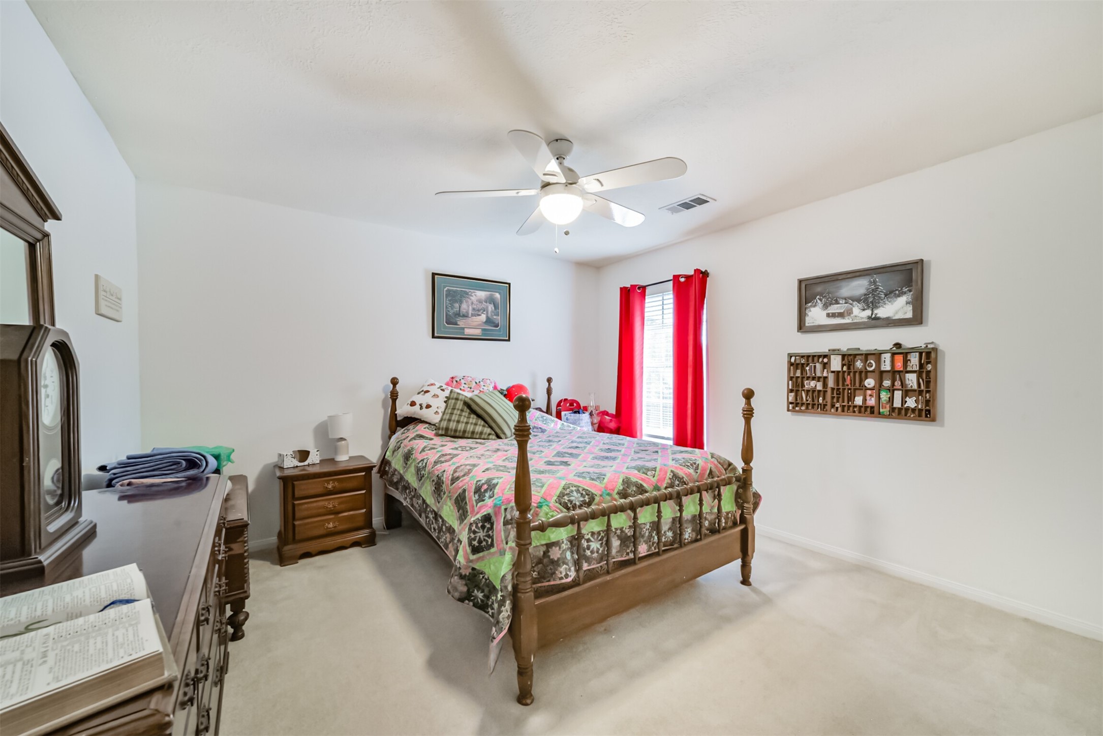 Upstairs bedroom 2 features a ceiling fan, a light fixture, and window blinds with curtains.