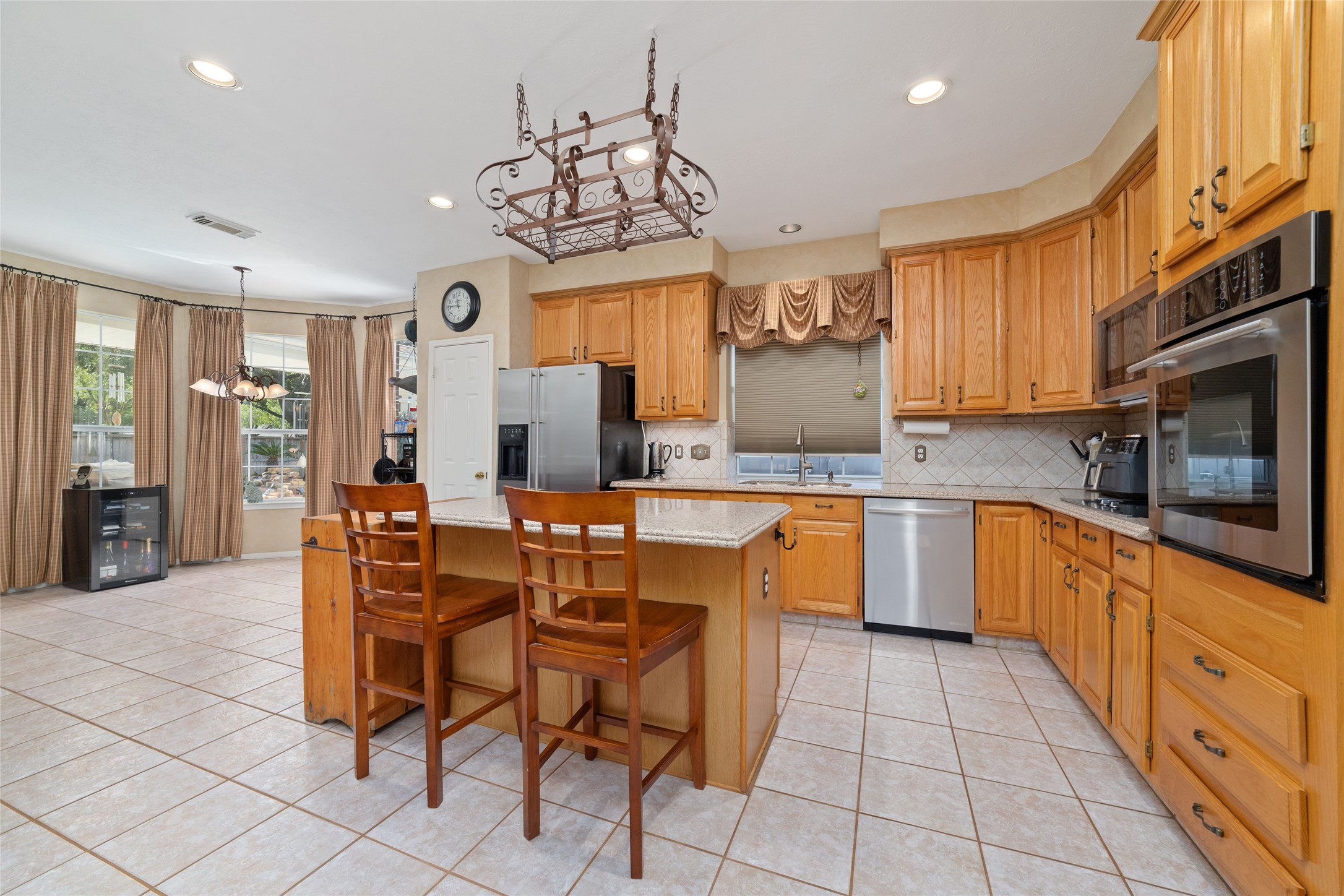 Open kitchen with central island, breakfast seating, double ovens, and convenient access to the breakfast room.