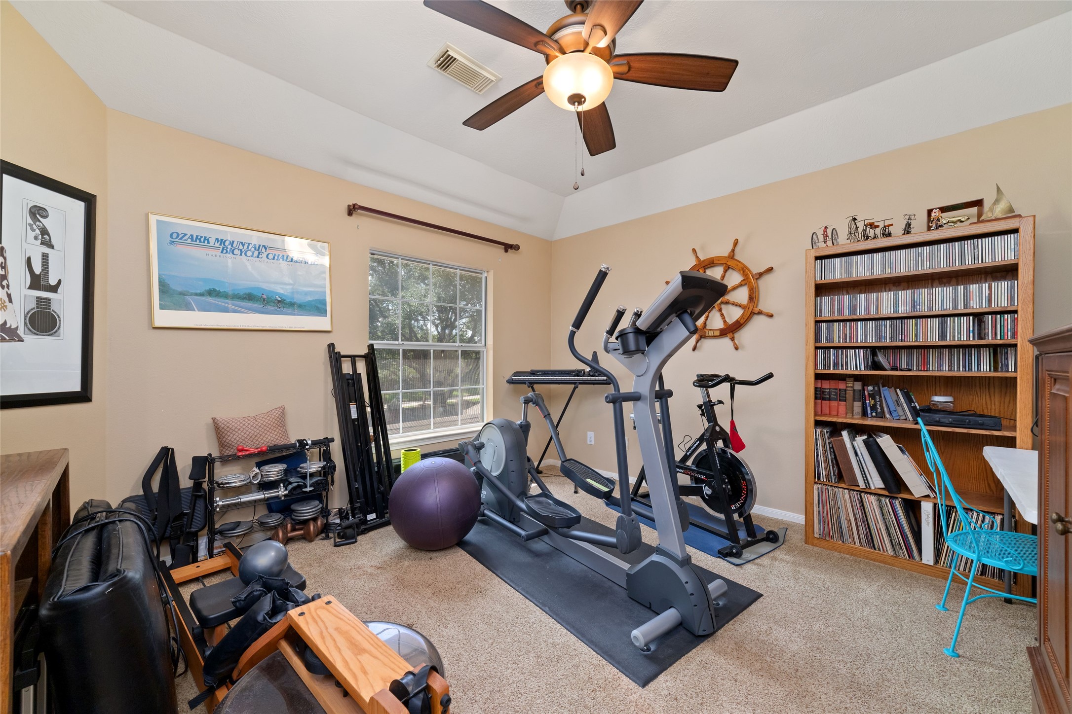Flexible upstairs room currently used as a home gym and suitable for a bedroom, hobby room, or additional workspace.