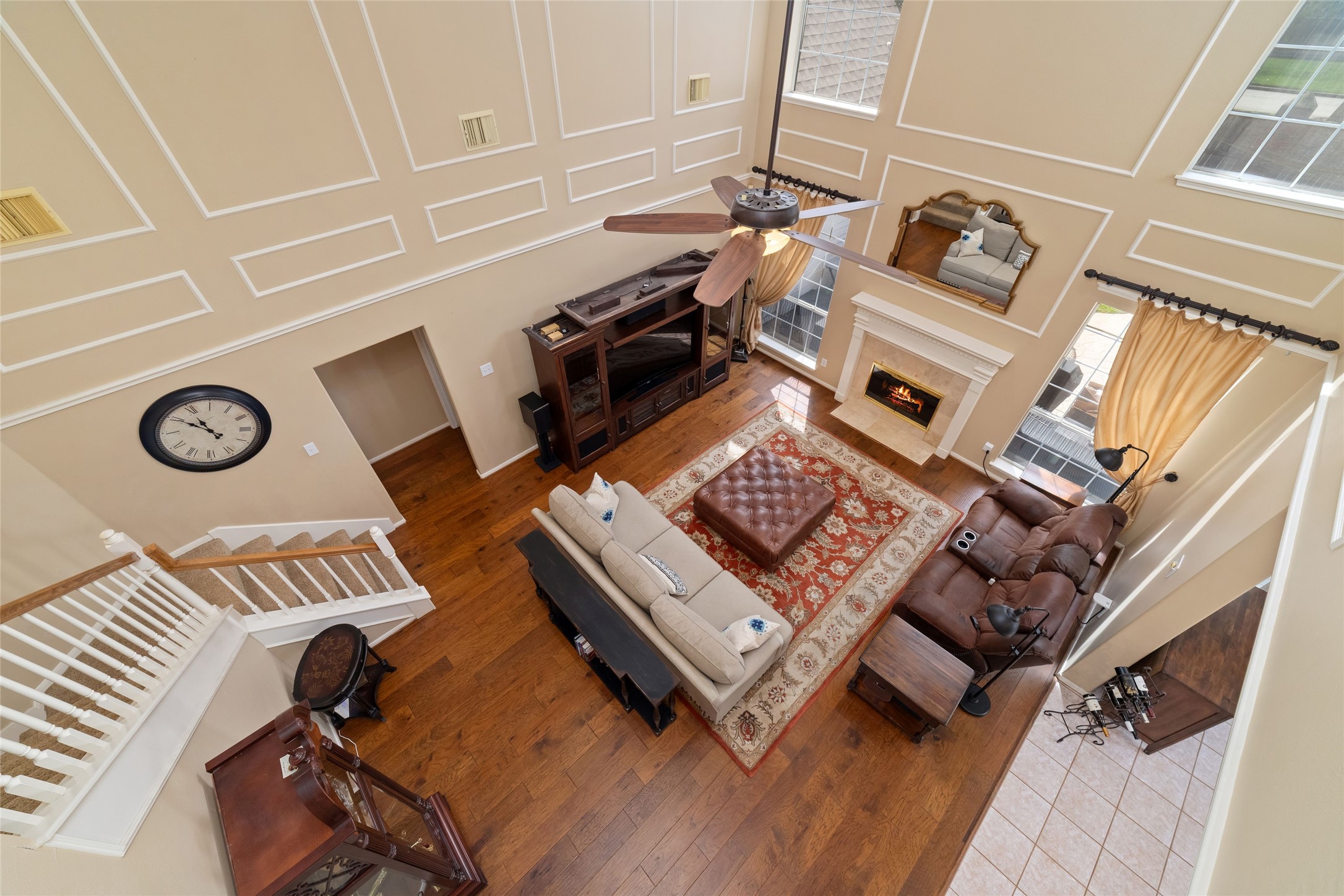 View from the second-floor overlook emphasizing the living rooms scale, tall windows, and open design.