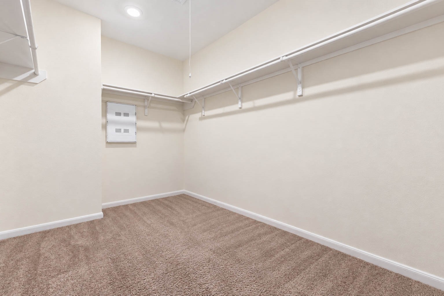 Completing this impressive retreat is an oversized walk-in closet with wraparound hanging rods, built-in shelving, & abundant space for organizing clothing, shoes, & accessories.