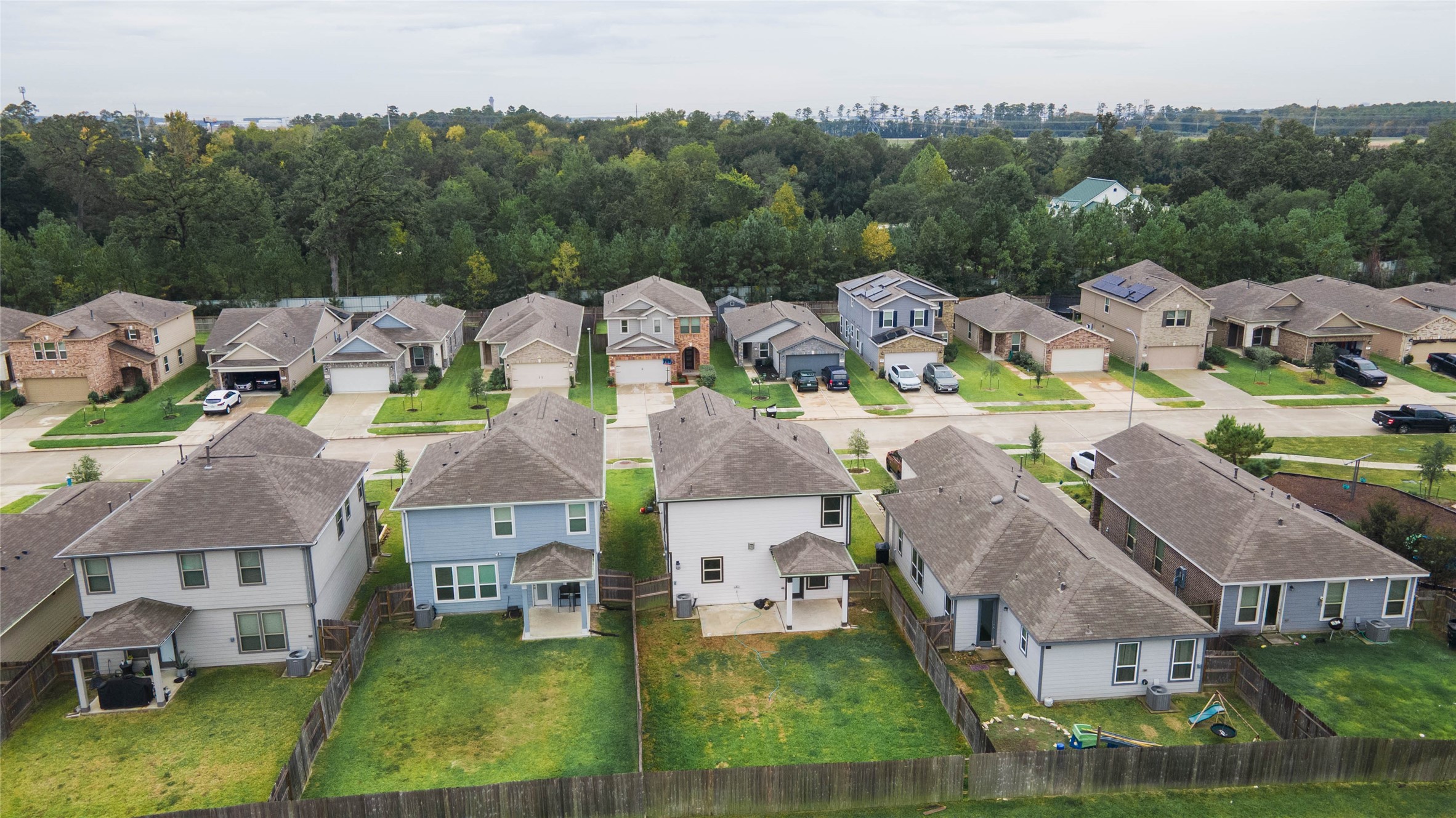 This beautiful aerial view showcases the home's spacious backyard, covered patio, & desirable location with no immediate rear neighbors!