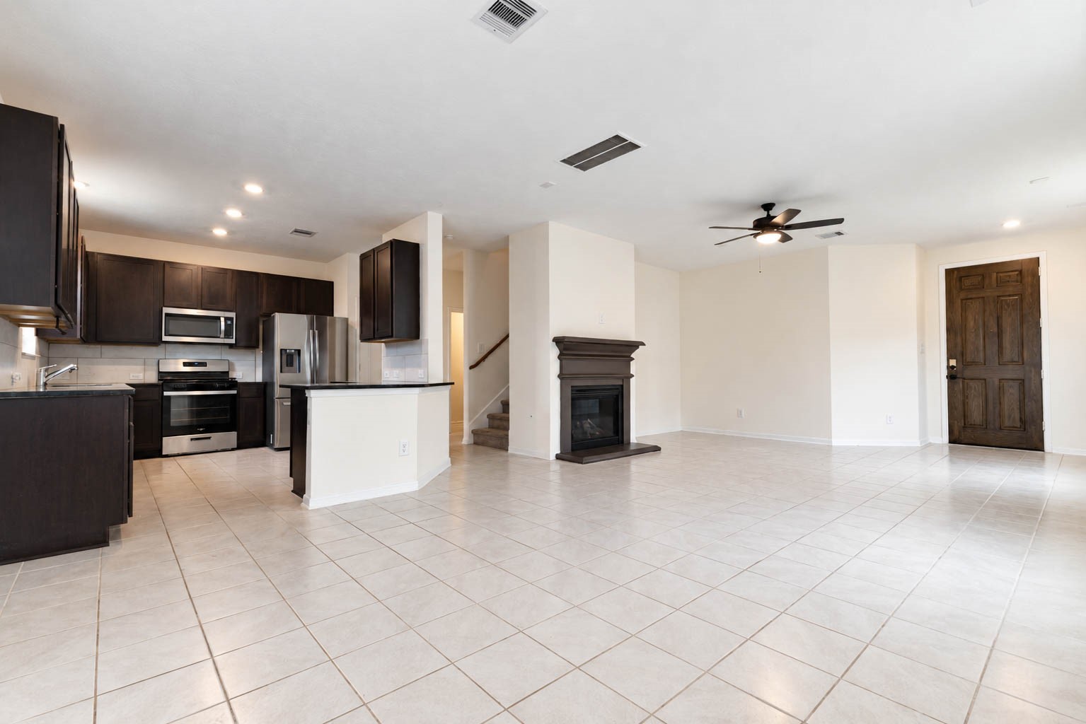 The open-concept floor plan connects the dining area with the beautifully appointed kitchen & adjoining family room. Gleaming tile flooring extends throughout, adding a touch of elegance & continuity to the living spaces.