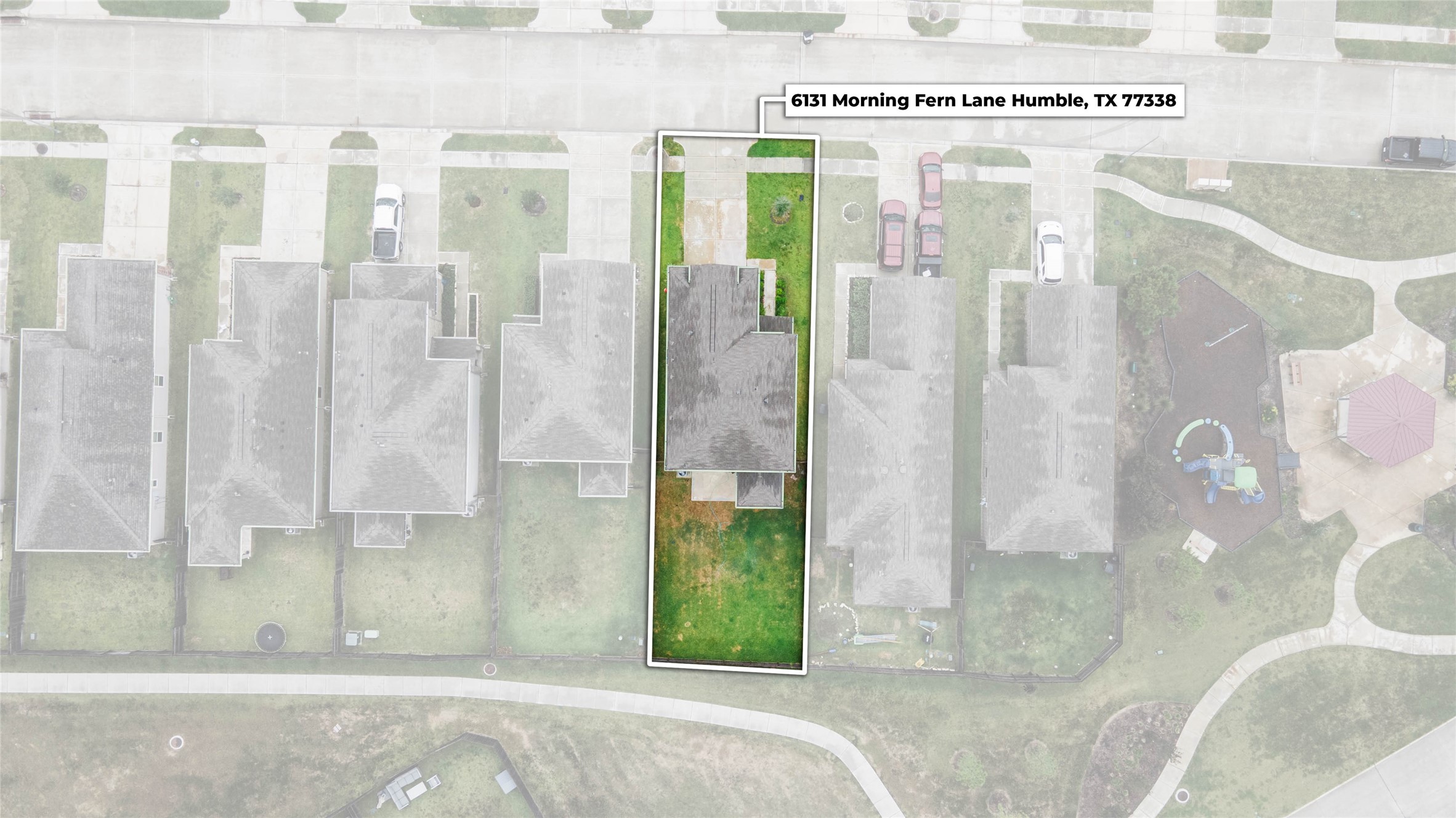 A bird's-eye view highlights the home's thoughtfully positioned lot, featuring a spacious driveway, covered back patio, & fully fenced backyard.