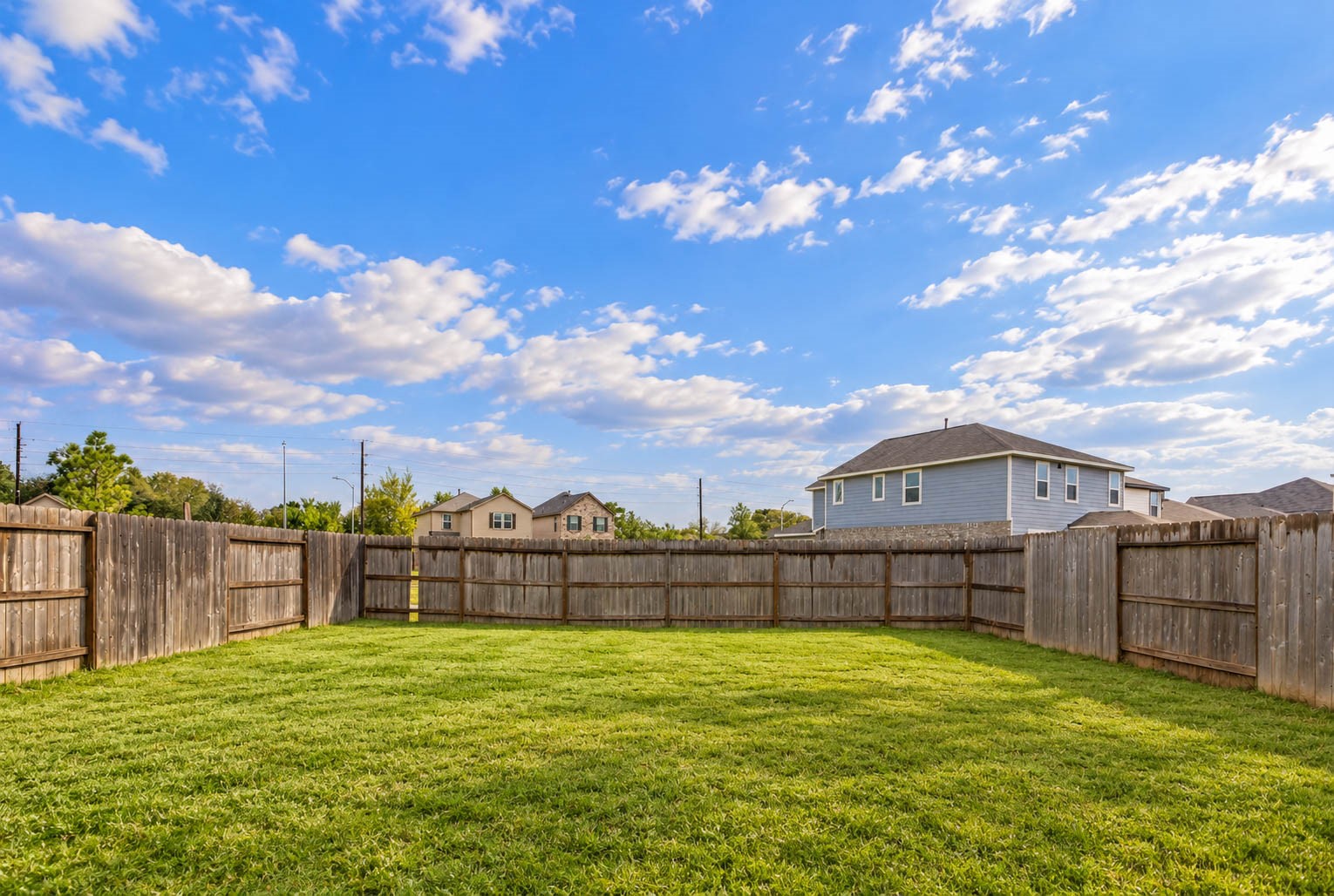 Step outside to discover this spacious, fully fenced backyard offering an expansive grassy lawn with plenty of room for creating your own personalized outdoor retreat!