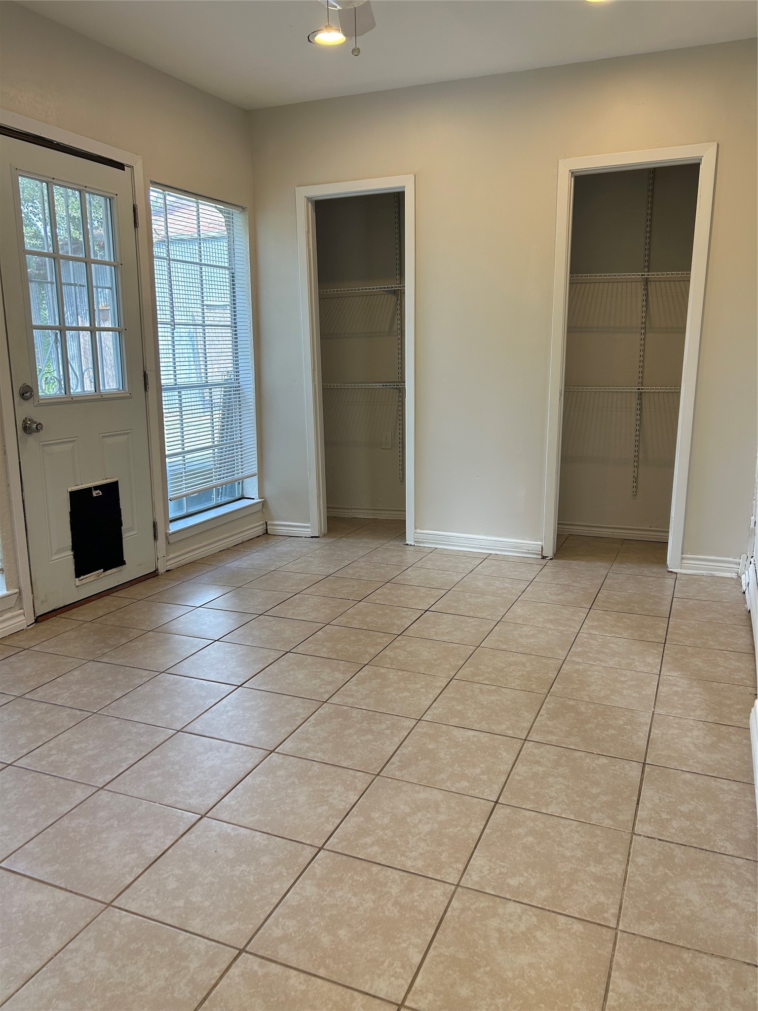 Another view of Bedroom 3. Door leads to back yard.