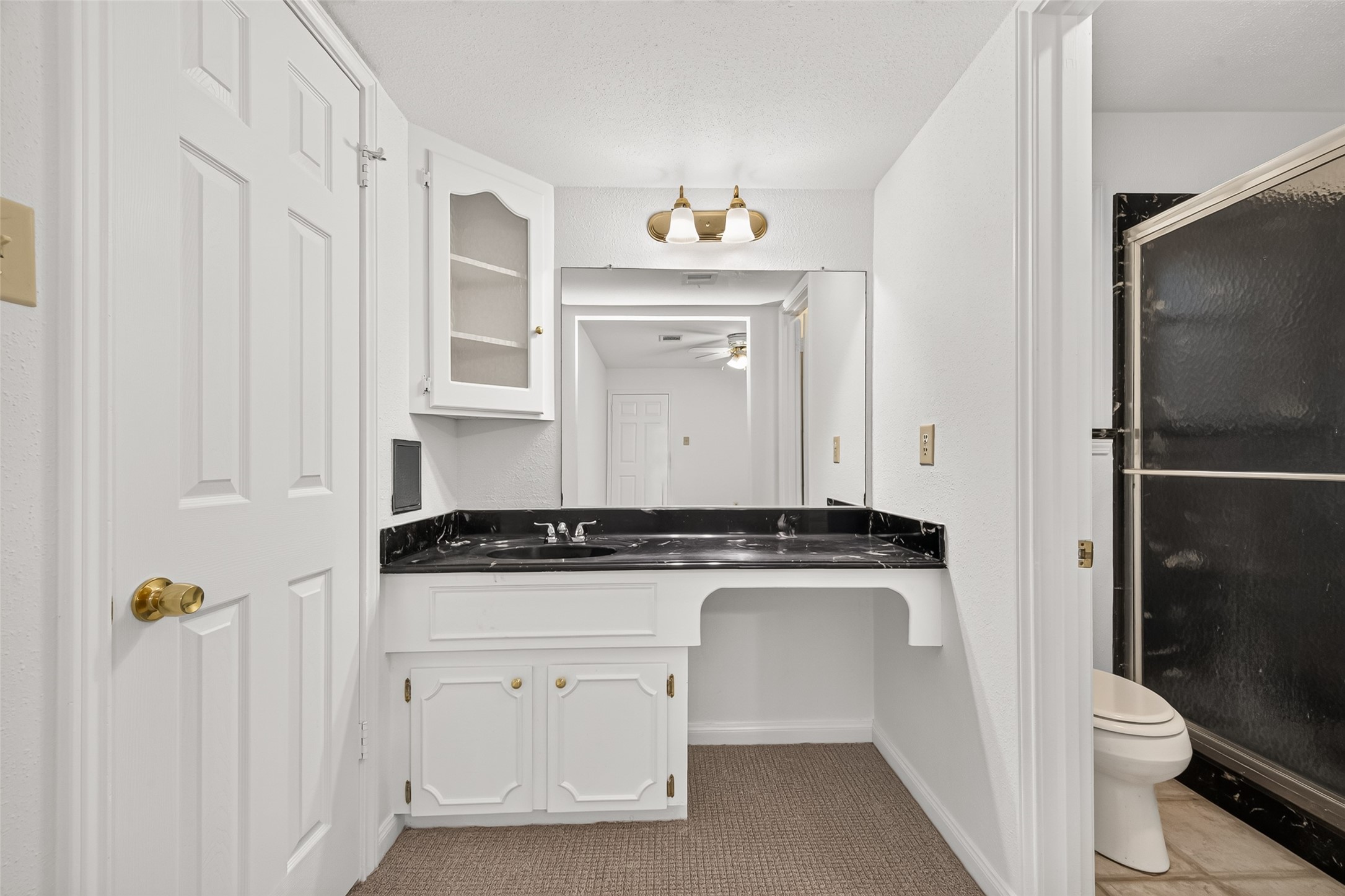 A dedicated space for your morning routine, conveniently located just outside the private bathroom with an enclosed shower.