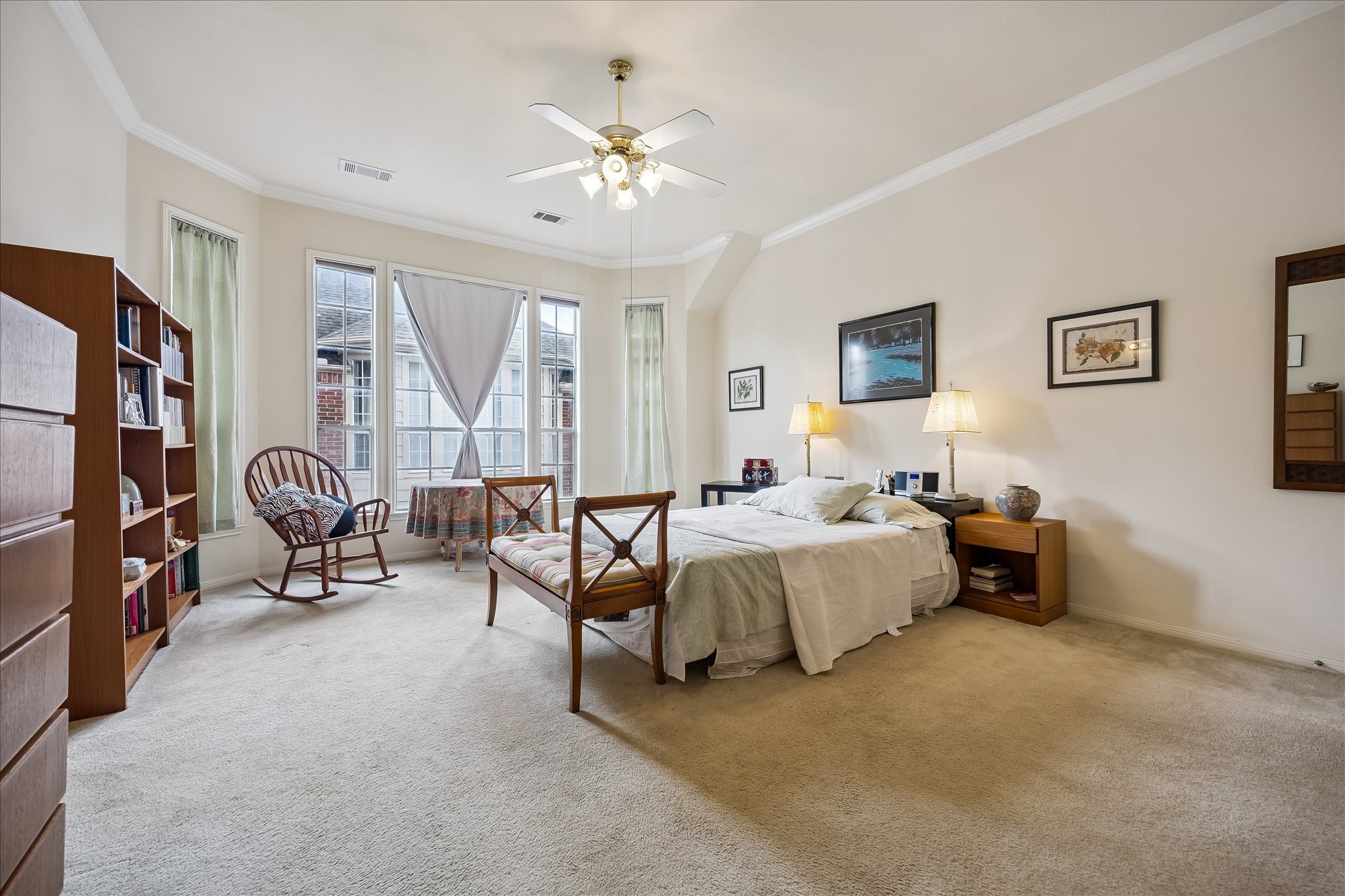 Huge Primary Bedroom with space for a reading area & the high ceilings just add to how welcoming this room feels.