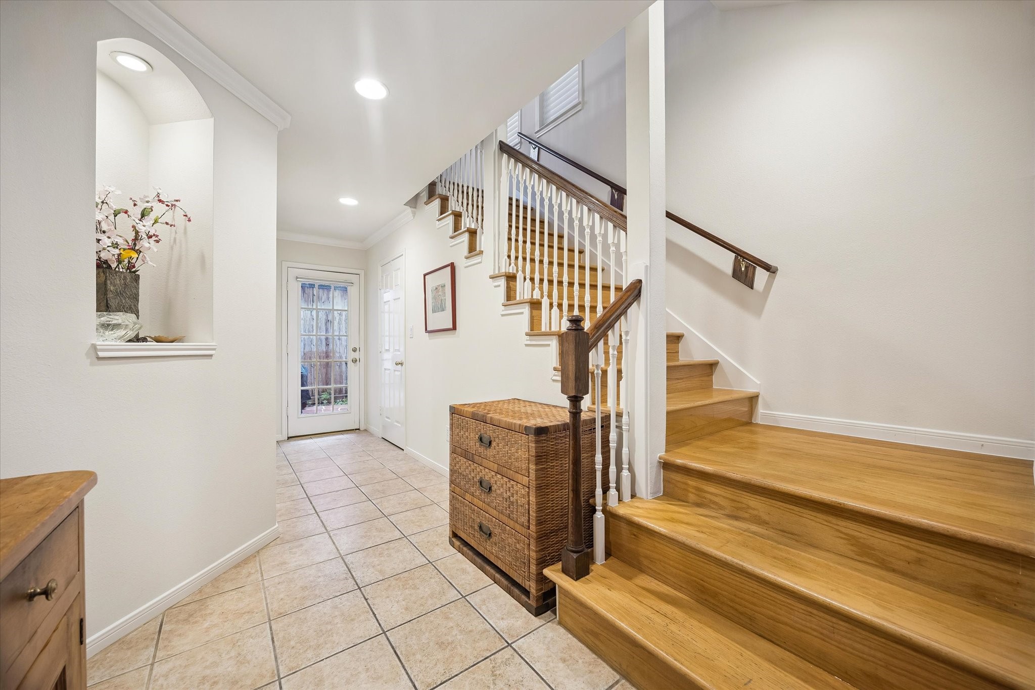 Welcoming foyer w/ one of the art niches on left. Large walk-in closet is nicely hidden under the stairs on the right.