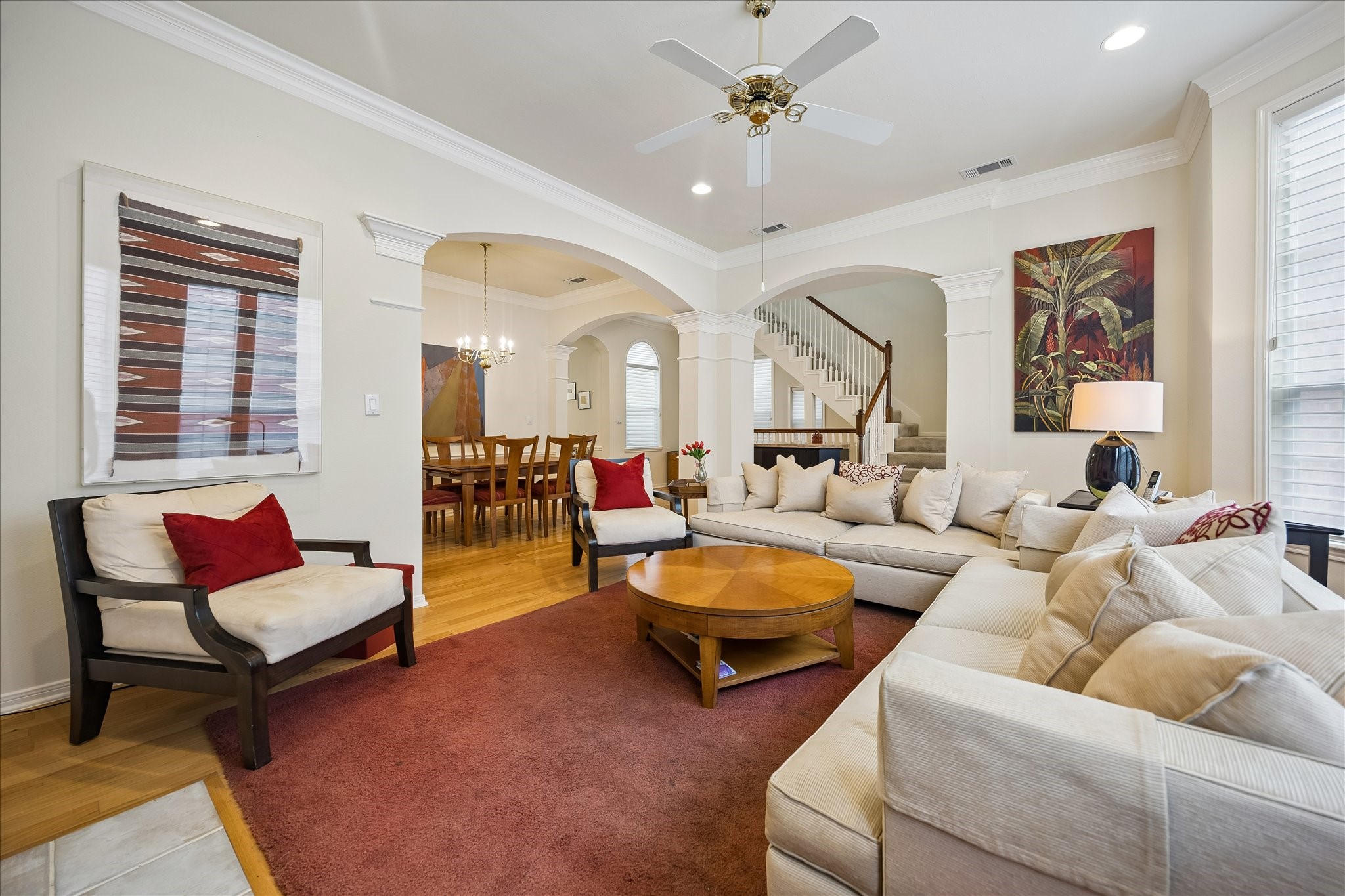 High ceilings in this living room allow the natural light in and there are custom shades throughout that you can adjust.