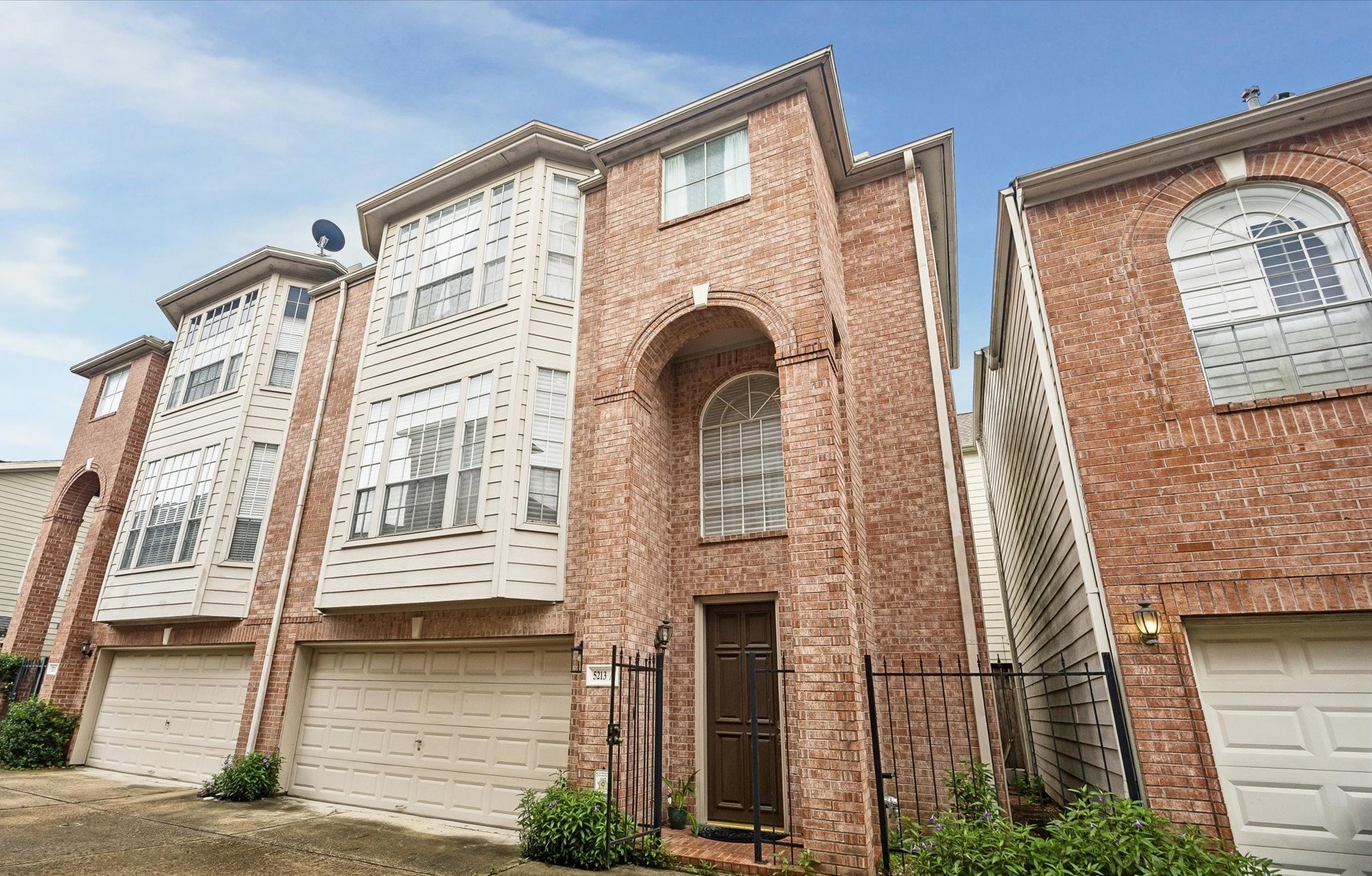 Attractive brick facade; gated front door & attached on only 1 side
