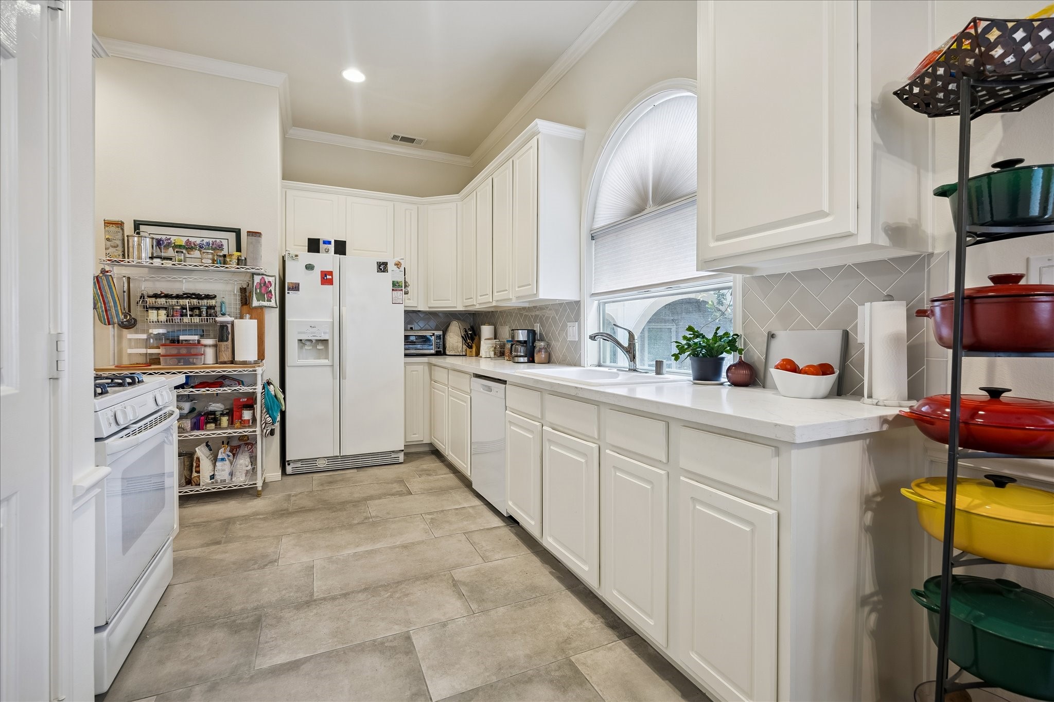 Nice bright kitchen w/ plenty of counterspace & a pantry. Refrigerator included. Laundry room is just to the left of kitchen from this vantage point.