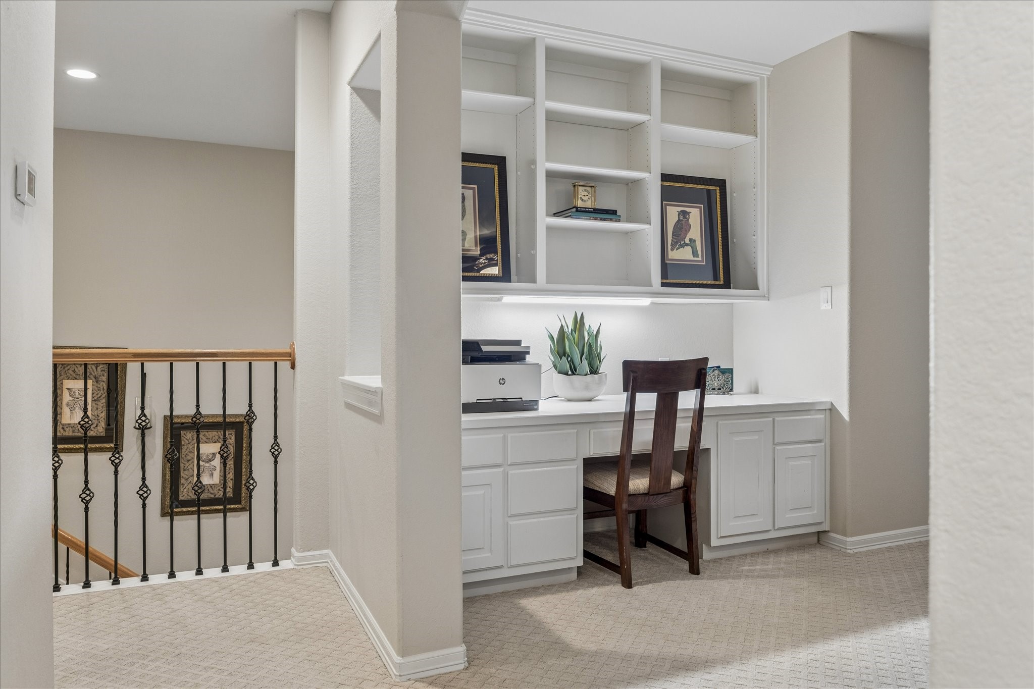 Built-in desk with open shelving above. Attractive cut out niches open to the hall.