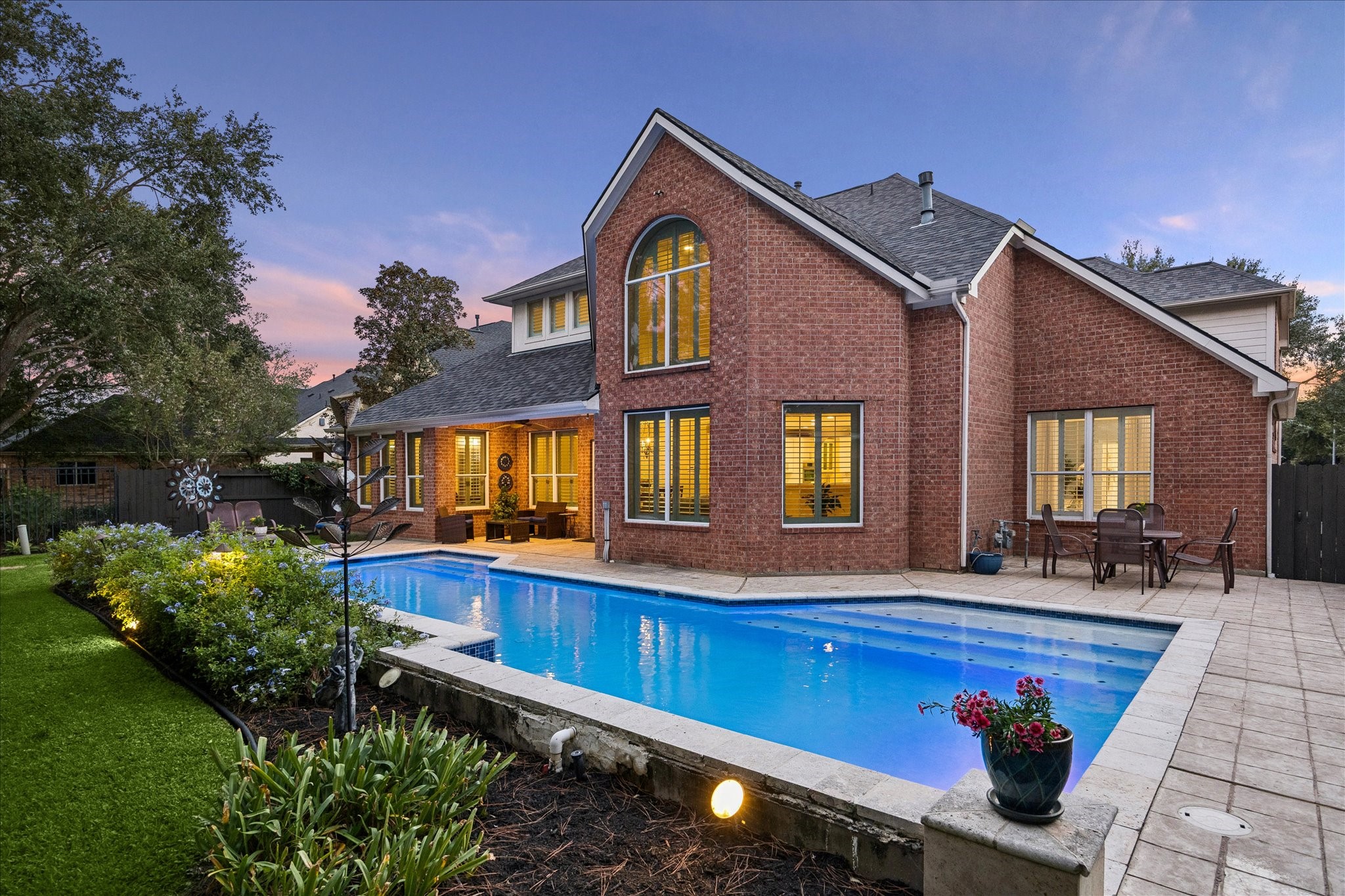 Another angle of the beautifully landscaped backyard with resurfaced pool (2024).