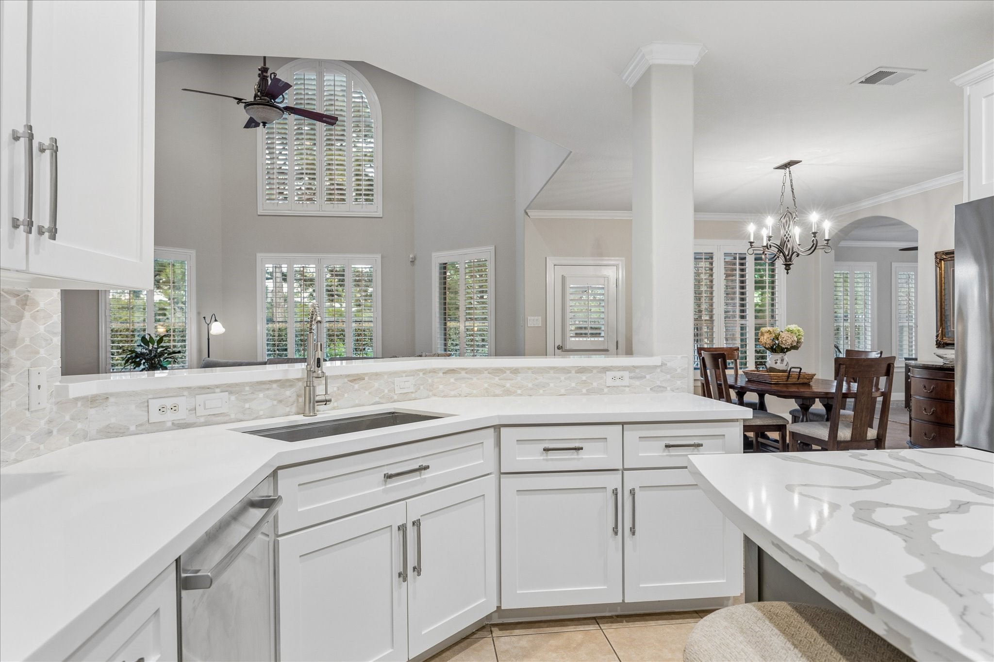 Open to the main living spaces, the heart-of-the-home kitchen keeps you connected to the conversation, gathering, and everyday moments happening around you. The cabinetry has recently been refreshed with paint and stylish hardware.