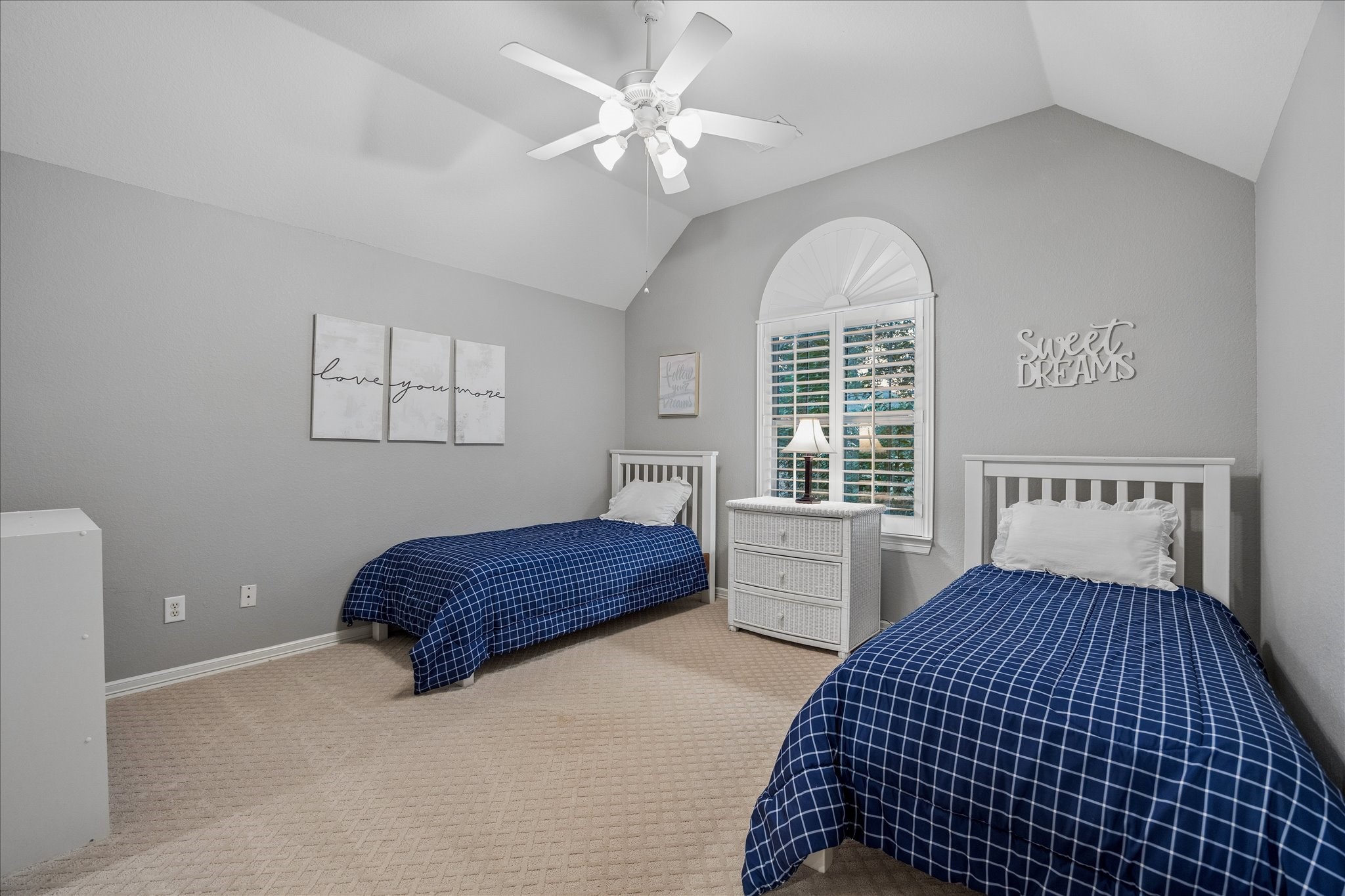The last bedroom with its own private bath is located on the opposite side of the home. It has a vaulted ceiling, an arched window with plantation shutters, and a spacious walk-in closet.